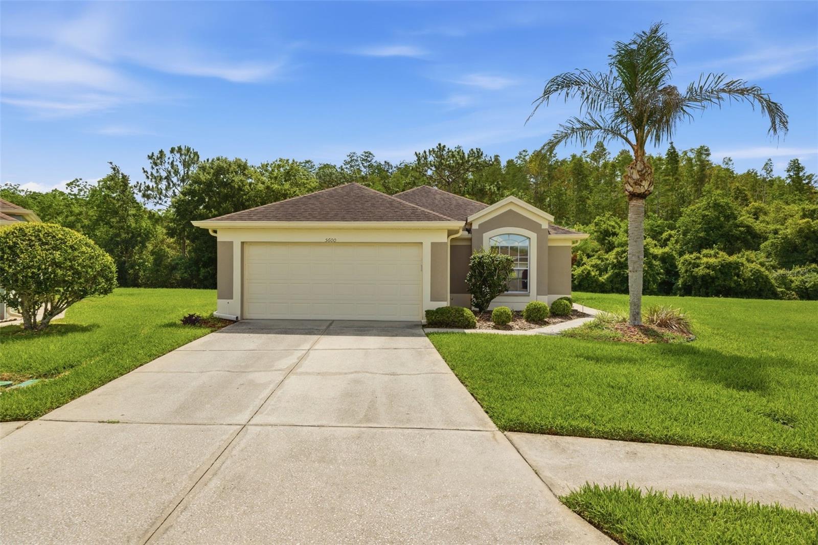 Located on a CUL-DE-SAC on a pie-shaped lot with CONSERVATION VIEW in the highly desirable Lexington Oaks Golf Community within the GATED Churchill Villas neighborhood, this MAINTENANCE-FREE, move-in-ready Magnolia floor plan offers comfort, convenience, and pride of ownership throughout. Beautiful curb appeal welcomes you home with a lush, manicured lawn and an attractive landscaped walkway leading to a private side entry. Inside, the bright and inviting foyer opens to a large front bedroom featuring double doors, currently utilized as a home office. The thoughtfully designed layout continues with a secondary bedroom, full guest bath, and indoor utility room conveniently located down the hall. Privately situated at the rear of the home, the spacious primary suite features a large walk-in closet and an en-suite bathroom complete with dual vanities, a walk-in shower with built-in seating, and a separate water closet. The charming galley-style kitchen offers plenty of cabinetry with granite countertops, an eat-in dining area, breakfast bar seating, and abundant natural light. Overlooking the open-concept living and dining room combination, this space creates the perfect setting for everyday living and entertaining. Sliding glass doors lead to the enclosed patio, ideal for relaxing with your morning coffee, reading, or hosting guests while enjoying the peaceful outdoor setting. Situated within the amenity-rich Lexington Oaks community, residents enjoy access to a championship 18-hole pay-as-you-go golf course, a heated community pool, fitness center, tennis, basketball courts, playground, splash pad, and scenic walking trails, all conveniently located near I-75, shopping, dining, hospitals, and top Wesley Chapel destinations.