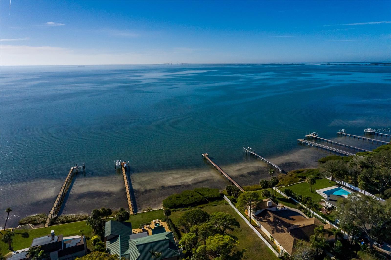 Welcome to the iconic Pink Streets of St. Petersburg—an extraordinary opportunity to create your waterfront dream home. Located at 1060 Friendly Way South, this rare open-water lot offers breathtaking, unobstructed views of Sunshine Skyway Bridge and the sparkling waters of Tampa Bay. Wake up to spectacular sunrises, watch boats glide by, and enjoy the ever-changing waterfront scenery from one of St. Pete’s most coveted neighborhoods. This expansive homesite spans over 17,000 square feet, measuring approximately 92 x 193, and totals about 0.41 acres, providing ample space to design a custom luxury residence with outdoor living, pool, and dock potential. The Pink Streets community is beloved for its vibrant character, coastal charm, walkability, and tight-knit neighborhood feel, all while being just minutes from Downtown St. Petersburg, world-class dining, waterfront parks, arts, and entertainment.
Enjoy effortless access to the Gulf beaches, major interstates, and regional travel hubs—approximately 25 minutes to Tampa International Airport and St. Pete–Clearwater International Airport, with Sarasota just about 25 miles away. This premier waterfront location offers the perfect blend of tranquility, convenience, and investment potential. Opportunities like this are exceptionally rare—build your legacy on one of St. Petersburg’s most iconic waterfront streets.