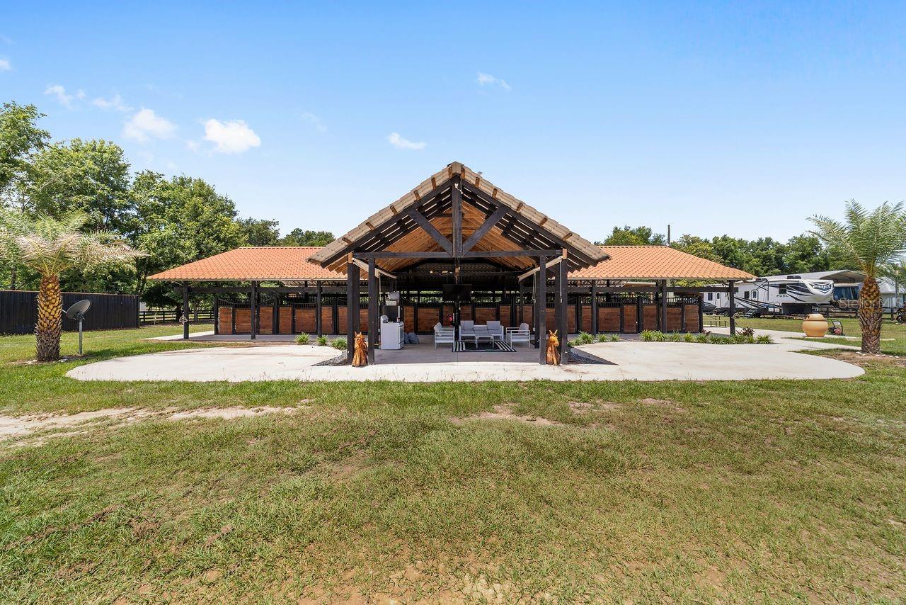 OWNER FINANCING AVAILABLE....    STUNNING WORKING MINI FARM featuring 26 horse stalls and ready for immediate use and occupancy! Excellent opportunity for WEC Show season, training, boarding, Paso Fino horses, or equestrian investment. The property features 26 horse stalls including 16 main stalls approximately 10x10 and 10 wooden stalls approximately 12x12, all equipped with automatic waterers. Includes a large training track approximately 100 x 60, riding arena, covered 50-foot round pen, and 6 paddocks ideal for horse training and management. This fully operational equestrian property also offers a fly spray system, wash area with space for washer and dryer, hot water heater, storage areas for both new and used shavings, and a storage container for feed and tools. Property includes well water, electricity ready for a future permanent residence, and a security camera system. The beautifully landscaped entrance with palm trees and Spanish-style roof accents gives the property exceptional charm and character. Relax and enjoy the horses from the covered terrace sitting area. Additional features include space for 2 RVs with 30 and 50 amp hookups and two separate septic systems. Conveniently located approximately 25-30 minutes from WEC and only 15 minutes from Jockey Club facilities, with nearby feed stores and shopping in Citra and Anthony. The large RV may be included as part of the negotiation  . Move-in ready equestrian facility with endless possibilities! MOTIVATED SELLERS! ¡HABLAMOS ESPAÑOL!