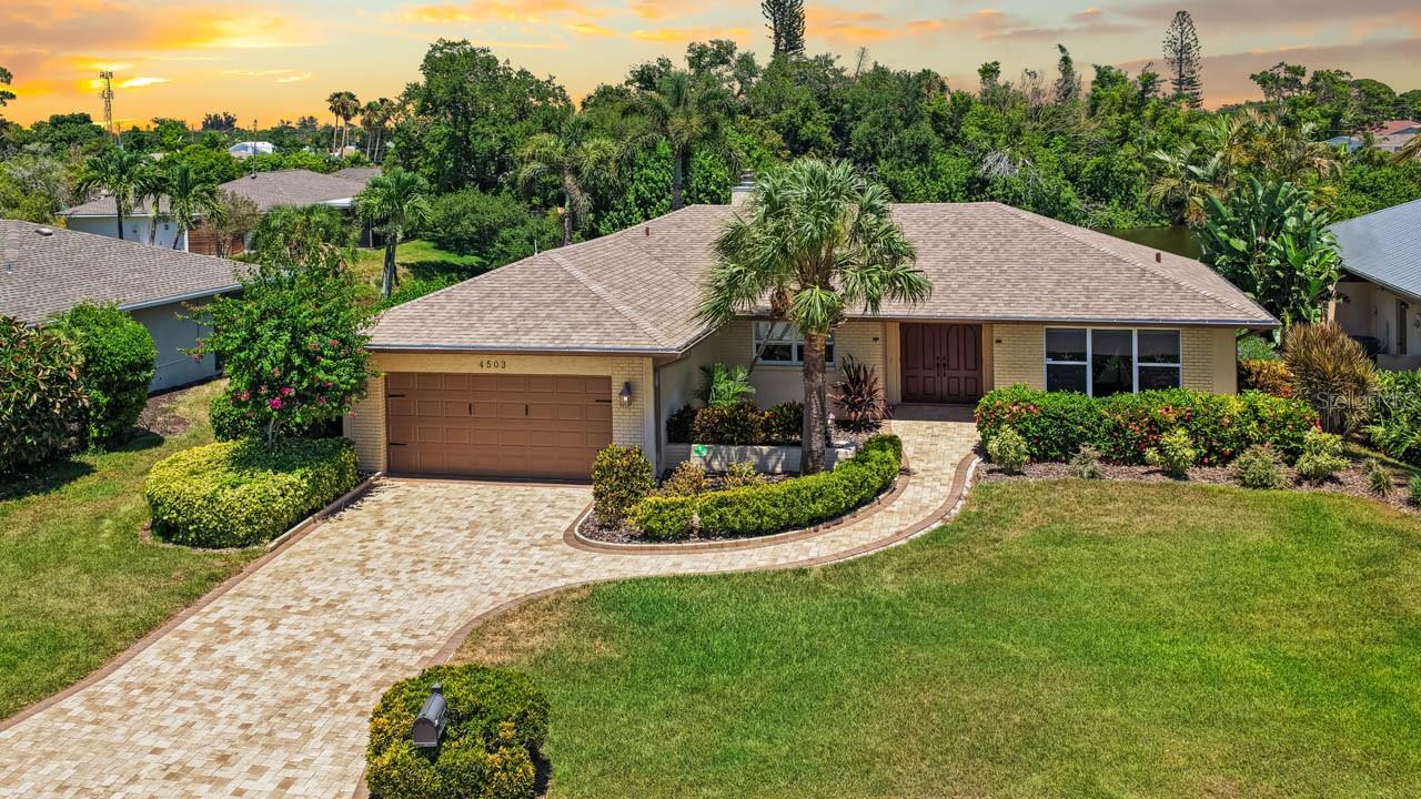 Lakefront in Bay Lake Estates, fully furnished, with a brand new roof and brand new seawall already done. Move in with nothing to buy. This 3 bedroom, 2 bath, 2 car garage block home sits on a 0.32 acre lakefront lot in West Bradenton, minutes from Anna Maria Island. A brand new roof went on in January 2025 and 76 feet of new seawall lines the water, so the big ticket items are handled before you ever unpack. Open floorplan ties the great room, dining, and kitchen together with stone counters and a counter height eat in space. Split bedroom layout puts the primary suite on its own side with a walk in closet. Wood burning fireplace, impact windows throughout, water softener, and a 26 foot covered lanai looking out over the water. One story, slab built, no steps. Sold turnkey furnished, furniture included, so there is no moving truck to haul down. Perfect for a seasonal escape or a full time move. HOA covers lawn care, irrigation, and lake maintenance. No CDD. Homestead eligible. Near Cortez fishing village, IMG Academy, waterfront dining, shopping, and hospitals, with both Sarasota and Tampa airports in reach.