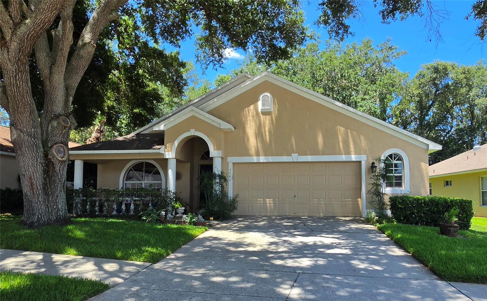 Welcome to the highly desirable Twin Lakes community! This well maintained 4 bedroom, 2 bathroom home offers a spacious and functional layout designed for comfortable family living.  As you step through the front door, you're greeted by a bright and inviting living and dining area, perfect for gatherings.  The kitchen features a convenient center island, providing additional counter space, along with a casual dining area.  The split-bedroom floor plan allows privacy for the primary suite while providing flexibility for guest rooms, a home office or hobby space.  The primary bedroom is filled with natural light and features an en-suite bathroom complete with a relaxing garden tub and seperate shower.  Enjoy the Florida lifestyle year-round in the versatile patio area, where you can open the windows to enjoy fresh air or enclose  the space for additional indoor living.  The backyard deck is great for barbeques and unwinding outdoors.  The attached two-car garage provides ample room for vehicles, storage, and hobbies.  Residents of Twin Lakes enjoy access to excellent schools, a community pool, playground, and low HOA fees.  Conveniently located near shopping and dining and everyday amenities, this home provides the perfect blend of comfort, convenience, and community living.