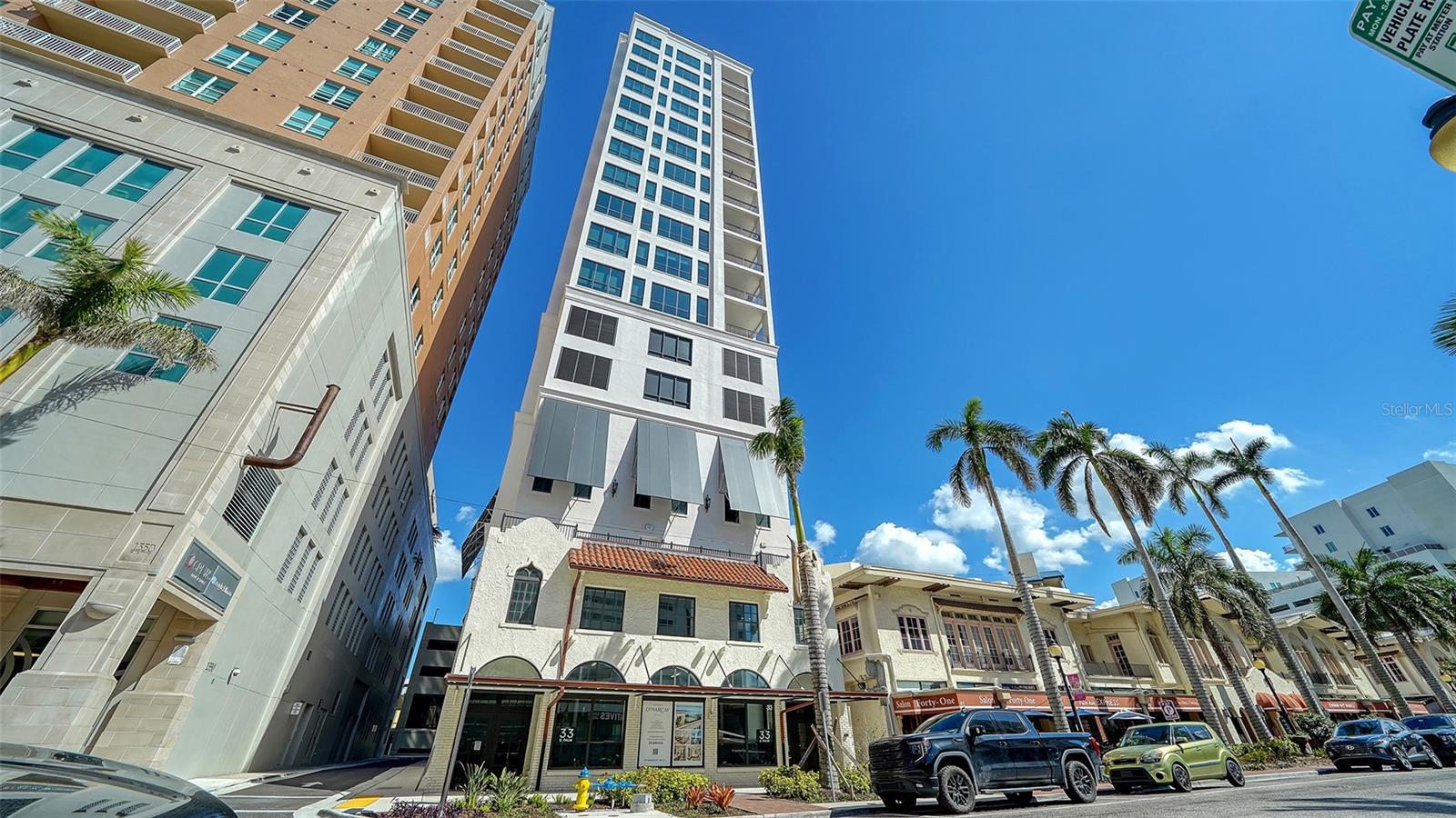Priced BELOW $1M for a BRAND NEW LUXURY BUILDING on Palm Avenue in the heart of DOWNTOWN SARASOTA! Recently completed, this residence offers the rare opportunity to enjoy the ease and appeal of new construction. Thoughtful upgrades include hardwood flooring, remote-controlled window treatments throughout, and designer lighting fixtures.  The open floor plan is both spacious and welcoming, filled with natural light from floor-to-ceiling windows that frame charming city views. The kitchen is beautifully appointed with paneled appliances, a natural gas cooktop, and a pantry, making it as functional as it is stylish.  The primary suite features a generous walk-in closet and a beautifully appointed ensuite bath. A versatile second bedroom may also serve as a den or home office, with a guest bath conveniently located just across the hall.  The DeMarcay is a boutique building offering impressive amenities and attentive services. Residents enjoy a rooftop lounge with pool and entertaining areas, complete with gas grills—ideal for hosting friends and family. Valet parking and concierge trash pick-up add to the effortless, lock-and-leave lifestyle.  This is Sarasota living at its finest.