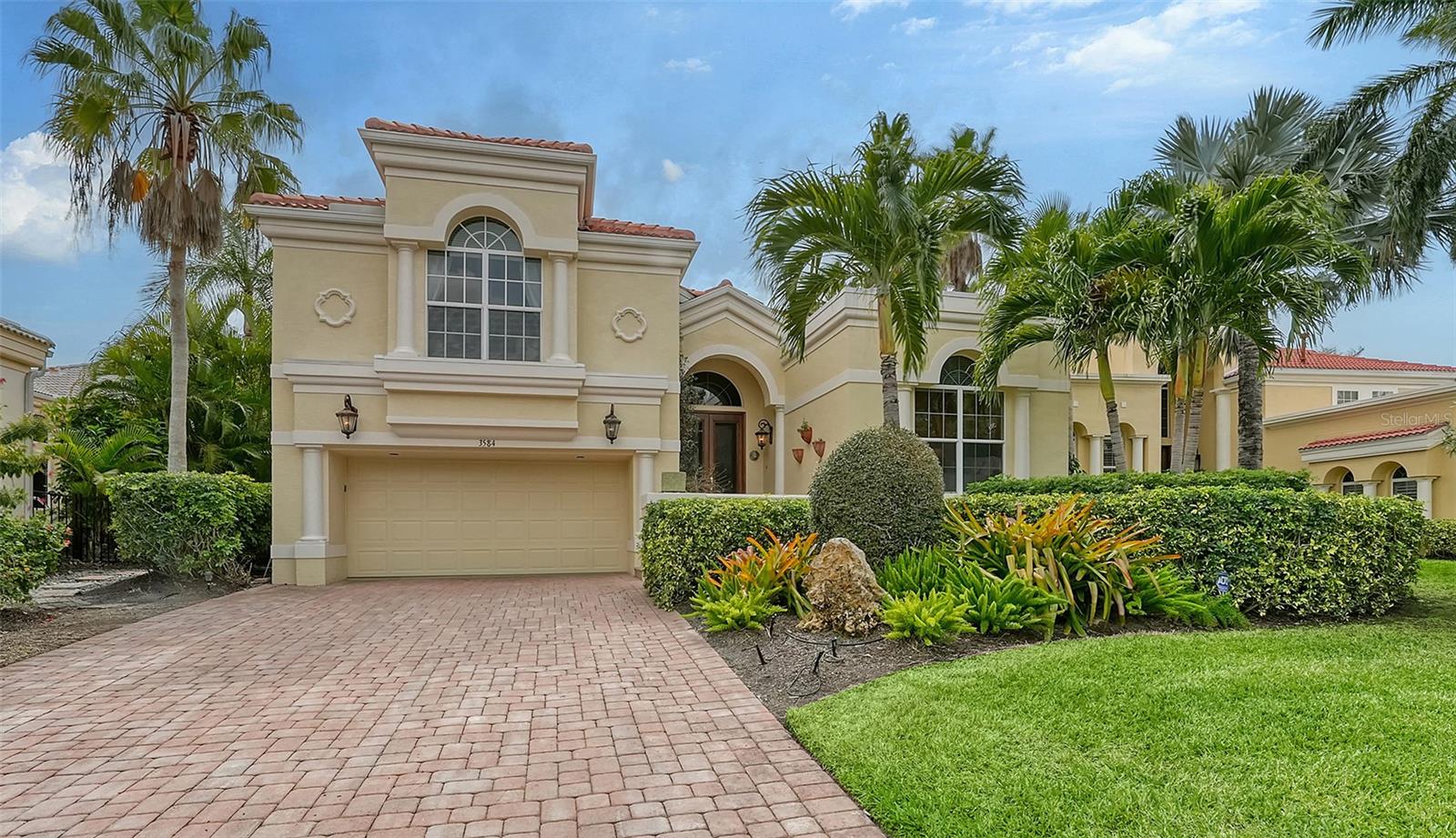 Delight in a lifestyle of tropical grandeur in this exquisite 3BR plus study, 2-story home nestled in the prestigious Queens Harbour on Longboat Key. Available for immediate occupancy, this residence offers the epitome of luxury waterfront living in one of the region’s most sought-after locations. As you step through the custom glass double entry doors, you are welcomed into the grand foyer, where a wall of sliders and transom windows invites natural light to dance upon the soaring 14 ft ceilings adorned with recessed lighting. Architectural and design touches throughout immediately convey its distinctive character. The spacious kitchen becomes a focal point, featuring a center island, luxury stone countertops, a gas cooktop and an inviting eat-in area with a picturesque view through aquarium glass to the pool and tranquil canal waters. The first floor boasts a guest suite with a full bath, providing comfort and convenience. The main bedroom is a spacious retreat, complete with a sitting area, slider access to the pool area and a primary bath featuring dual split vanities, a separate soaking tub and a walk-in shower. A well-appointed study with custom-built desk and shelving, along with a convenient half bath/powder room, complete the first floor. Ascending to the second floor, you'll find a guest suite with an en-suite bath, accompanied by a small separate room with a full-size Murphy bed, offering versatility and additional accommodation options. The spacious open paver brick pool area beckons you to unwind in its tropical oasis, complete with a covered eating area, gas-heated pool and spa. Enveloped by lush tropical landscaping, the outdoor space extends to your private dock on the deepwater canal, capable of accommodating a 50 ft+ boat. Residents of Queens Harbor enjoy a wealth of amenities as well as all the exclusive Gulf-front benefits of the Bay Isles Beach Club. Deepwater slips for lease or purchase and Longboat Key Golf & Tennis Country Club membership are available.