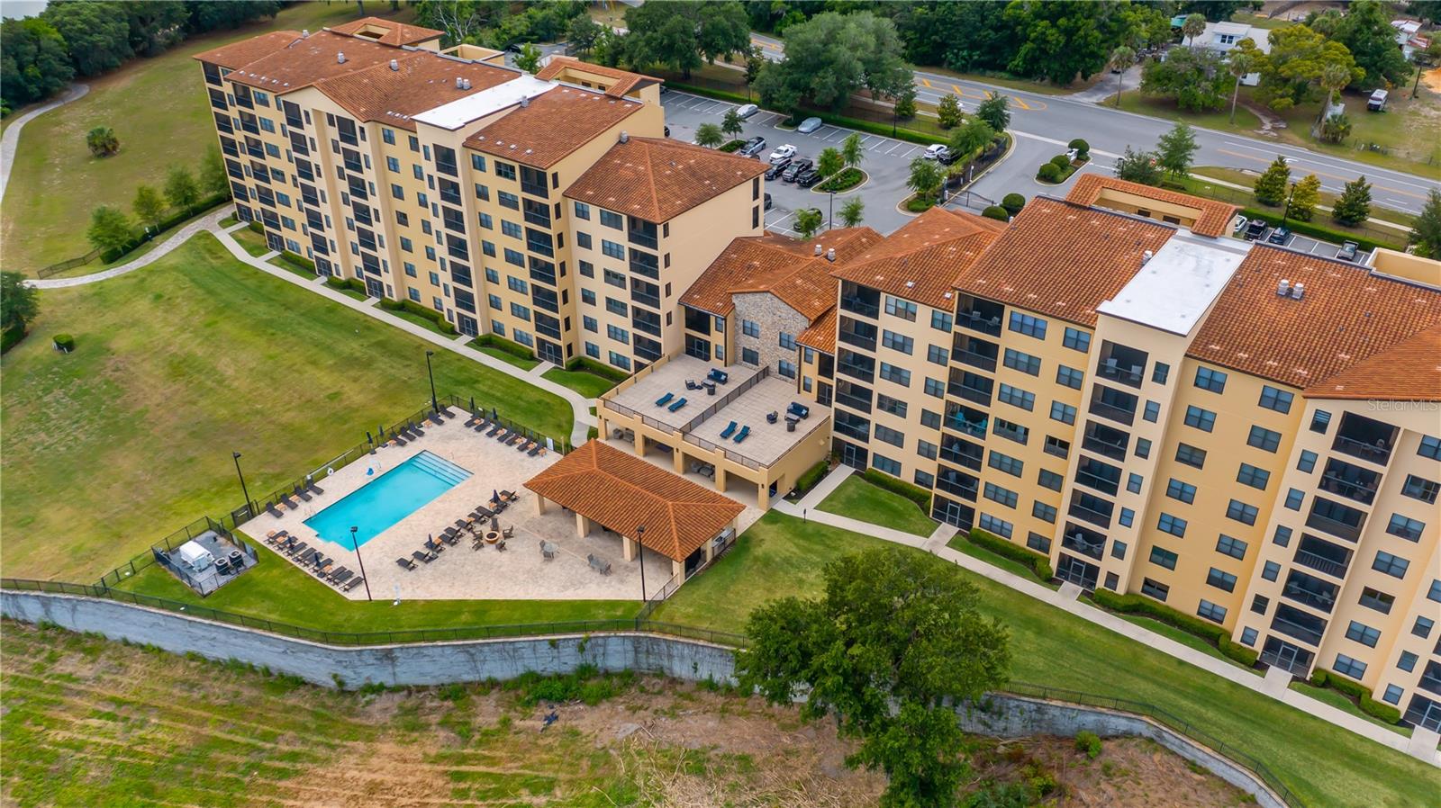 Nestled in the charming town of Montverde, this beautiful first-floor condo offers the perfect blend of comfort, convenience, and resort-style living. Ideally located near shopping, dining, major highways, Orlando's world-famous attractions, and the airport, Condo 105 features 2 bedrooms, 2.5 bathrooms, and 1,402 square feet of thoughtfully designed living space. Lovingly maintained by its original owner, this residence was the community's original model home and showcases quality finishes throughout.

Step inside to discover an open-concept floor plan highlighted by soaring ceilings that create a bright and airy atmosphere. Elegant tile flooring flows throughout the main living areas, offering both style and easy maintenance, while brand-new carpet adds warmth and comfort to the spacious bedrooms. The well-appointed kitchen serves as the heart of the home, featuring sparkling quartz countertops, stainless steel appliances, and ample space for everything from casual breakfasts to entertaining family and friends.

This move-in-ready condo has been thoughtfully updated with a new HVAC system and hot water heater, providing added peace of mind for years to come. The screened-in porch offers a private retreat where you can unwind while enjoying serene water views, creating the perfect backdrop for morning coffee or evening relaxation.

Just outside your front door, breathtaking views of Lake Sienna and mature trees provide a peaceful, picturesque setting. Residents enjoy access to the community pool and, as part of the Bella Collina community, have the opportunity to experience an unparalleled lifestyle with world-class amenities, including championship golf, a luxurious spa, fitness center, tennis and pickleball courts, scenic walking trails, fine dining, and a vibrant social calendar. Surrounded by rolling hills and stunning vistas, Bella Collina offers a unique resort-style experience unlike any other in Central Florida.

With modern updates, beautiful surroundings, and exceptional amenities, this condo delivers the very best in low-maintenance living. Don't miss this rare opportunity to own a beautifully maintained home in one of Central Florida's most sought-after communities. Schedule your private showing today!