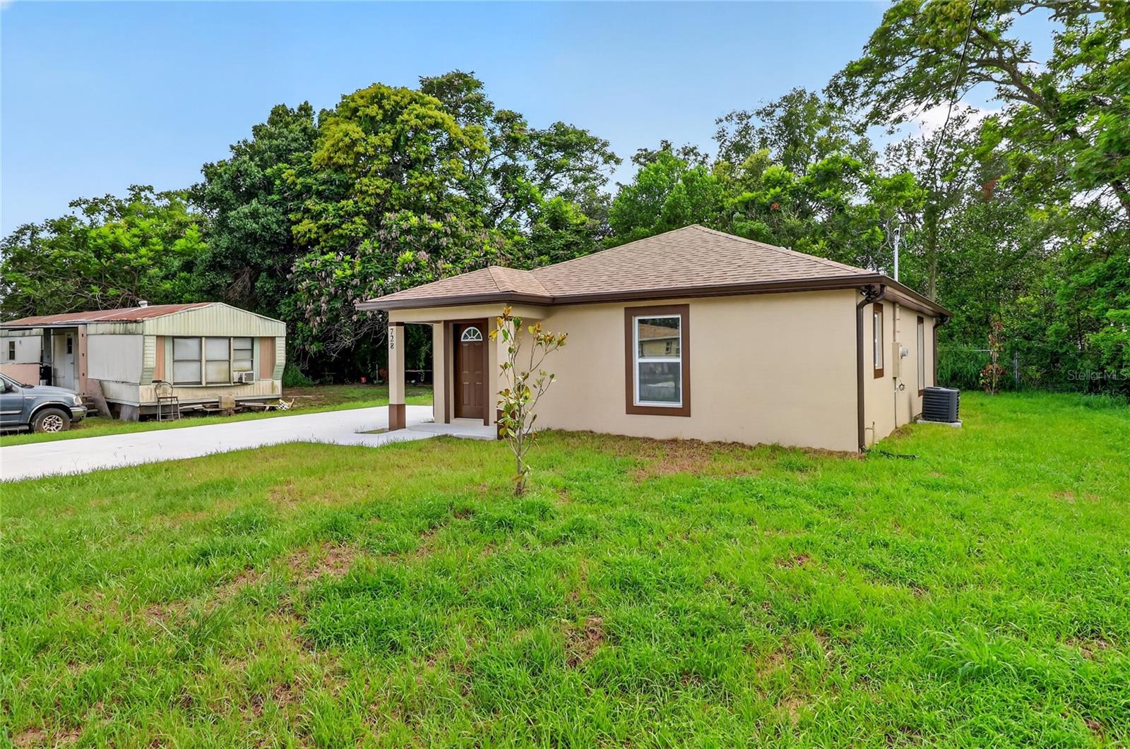 There’s something special about being the very first person to call a house home. From the moment you pull into the driveway, this brand-new Auburndale home offers the fresh start that so many buyers have been searching for, modern finishes, energy-efficient construction, and the confidence that comes with everything being new from day one. Designed for comfortable everyday living rather than simply maximizing square footage, the thoughtfully planned layout creates spaces that feel open, connected, and surprisingly spacious. The heart of the home brings the kitchen and great room together, making it easy to stay connected whether you're preparing dinner, helping with homework, or spending a quiet evening with family and friends. Natural light fills the living space, creating an inviting atmosphere you'll enjoy from your first cup of coffee each morning until the day's last conversation. The kitchen is designed for real life, offering stone countertops, luxury vinyl flooring, modern cabinetry, and a complete appliance package, including the refrigerator, range, microwave, dishwasher, washer, and dryer, so moving in can be as simple as unpacking your boxes. A pantry provides additional storage while keeping everything organized and within reach. The split-bedroom floor plan offers an ideal balance of privacy and functionality. Tucked away from the secondary bedrooms, the primary suite becomes your own peaceful retreat, complete with a walk-in closet and private bath. Two additional bedrooms provide flexible space for children, guests, a home office, or hobbies as your needs change over time. The centrally located indoor laundry room adds everyday convenience, eliminating trips to the garage or outside utility areas. Built with durable block construction, a concrete slab foundation, luxury vinyl flooring throughout, central air conditioning, underground utilities, and public water and sewer, this home delivers the low-maintenance lifestyle many buyers are looking for in today's market. Because everything is brand new, you'll spend less time worrying about repairs and more time enjoying homeownership. Outside, the yard offers just enough room to create your own outdoor retreat without demanding every weekend for maintenance. Location is where this home truly shines. Situated in Auburndale, you'll enjoy the charm of a growing Central Florida community known for its parks, lakes, local events, and small-town feel while remaining conveniently connected to everything the region has to offer. Downtown Auburndale, shopping, restaurants, schools, medical facilities, and everyday conveniences are all nearby, while quick access to Polk Parkway, I-4, and US-92 makes commuting to Lakeland, Winter Haven, Orlando, or Tampa remarkably convenient. Weekend adventures can include boating on nearby lakes, exploring Downtown Winter Haven, visiting Bonnet Springs Park, spending the day at LEGOLAND Florida Resort, or enjoying countless outdoor recreation opportunities throughout Polk County. For first-time homebuyers, this is more than a new house, it's the opportunity to begin building equity instead of paying rent while enjoying the comfort and confidence that only new construction can provide. If you've been waiting for an affordable new construction home in Central Florida that combines smart design, modern finishes, and an outstanding Auburndale location, this is one you'll want to experience for yourself.