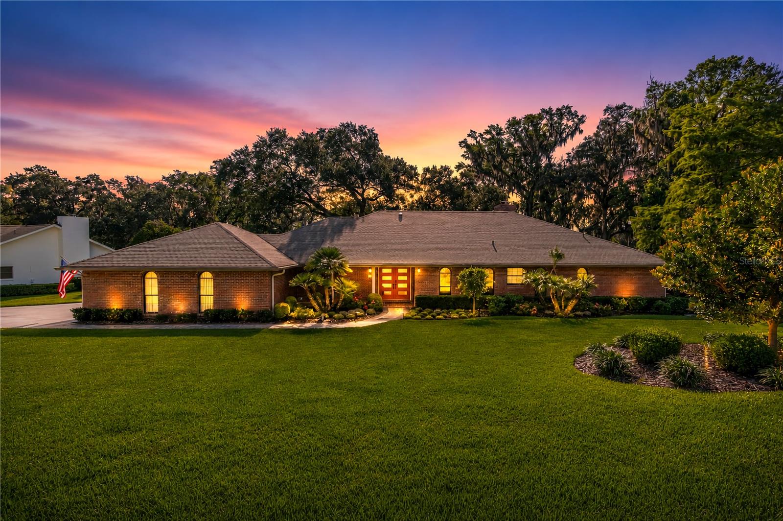 Positioned along the 18th Fairway of the Ocala National Golf Course, this extensively renovated home in Golden Hills provides timeless style, exceptional attention to detail, and over half an acre of beautifully landscaped grounds gently shaded by majestic oaks. With 3-bedrooms and 2-baths, the home spans 2,782 square feet of thoughtfully designed space, where every detail has been carefully updated within the past six years. The professionally remodeled kitchen features quality cabinetry, solid surface countertops, updated stainless steel appliances including a gas range, a large center island with breakfast bar, and opens seamlessly into the spacious living and dining areas. A striking wood-burning fireplace anchors the living room, while expansive windows showcase tranquil golf course views and fill the home with natural light. The spacious primary suite features two walk-in closets and a private en-suite bathroom with garden tub, walk-in shower, and dual vanities. Both bathrooms in the home have been completely remodeled, and luxury vinyl flooring extends throughout the bedrooms, bathrooms, and Florida room. Located at the back of the home, the Florida room is a warm and inviting space with huge windows overlooking the surrounding deck and the fairway beyond. Enjoy the area’s year-round sunshine on the expansive elevated Trex deck, creating the perfect setting for morning coffee, evening gatherings, or simply enjoying the picturesque surroundings. Professionally designed landscaping at the front and back of the home, extensive irrigation, inviting uplighting, retaining walls, and mature trees further enhance the property's curb appeal and outdoor enjoyment. Extensive capital improvements provide exceptional peace of mind, including a new roof, gutters, fascia and soffits, remodeled low-E windows, double front doors, stamped concrete driveway and walkways, epoxy garage flooring, garage door opener, HVAC system, water heaters, water softener, exterior paint, updated lighting and ceiling fans, interior and exterior door hardware, and a new septic system and drain field. Conveniently located across the street from Golden Ocala Golf & Equestrian Club and just minutes from the World Equestrian Center and a variety of shopping, dining, and everyday conveniences, this move-in-ready property offers the perfect combination of quality, comfort, and an outstanding golf course setting.
