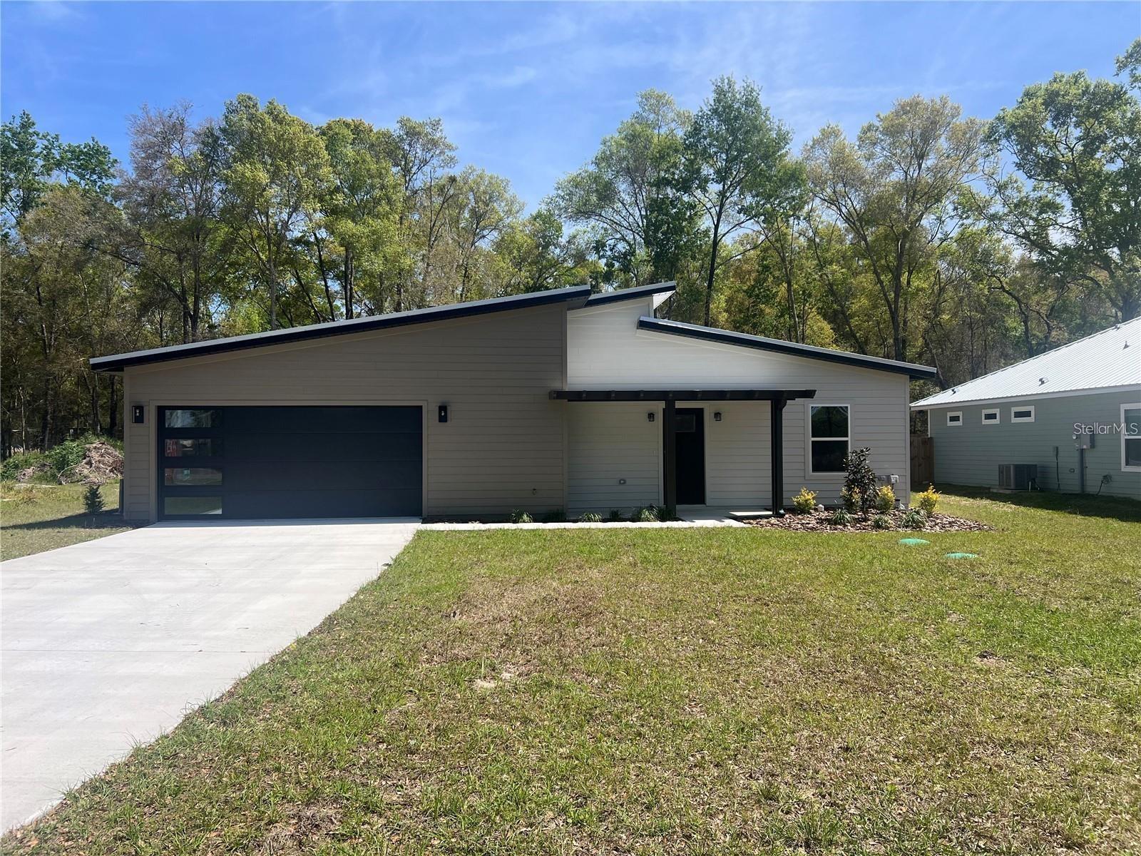 This 3/2 Contemporary style home is built by well know builder, Next Gen Custom Homes. This open floor plan flows seamlessly through the home. Primary bedroom is complete with a walk in closet, an en suite bathroom with double vanities and a walk in shower. Enjoy your coffee on the screened in back porch gazing out onto this oversized lot. Located just over the Gilchrist county line, you will enjoy lower Property taxes while still having the convenience of a short commute to the Newberry and Gainesville area.
