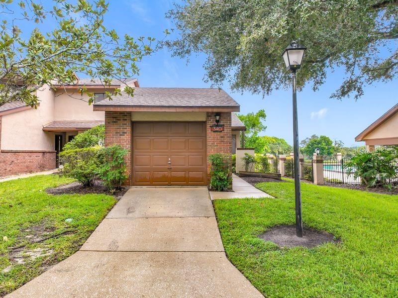 Virtually Staged. GOLF COURSE VIEW! Welcome to the tree-lined streets of Wekiva Villas on the Green. This ONE story, 2 bedroom, 2 bath condo is an END-unit located next to the community pool with views of the serene Wekiva Golf Course. There is a private driveway and a one car GARAGE with a full-size washer and dryer included. The A/C system was replaced in 2022. Inside you'll find high vaulted ceilings and an abundance of natural light from the windows in the living and dining room. The kitchen has a NEW stove AND dishwasher, modern granite countertops, tile backsplash, a quaint breakfast nook and a reverse osmosis water filtration system for the kitchen sink. Both bathrooms have been updated. The bedrooms are arranged away from one another for privacy, making it ideal for visiting guests. The large primary suite has a walk-in closet, an en-suite bathroom, vaulted ceiling, a TV set included, and a sliding door that opens out to the expansive covered wood deck porch. Great location to shopping, restaurants, Wekiva Springs State Park and one block from the Seminole County Public Library. Seminole County school system zoned for Wekiva Springs Elementary, Teague Middle and Lake Brantley High School which all received an "A" rating for the 2026 school year! Equal Housing Opportunity.