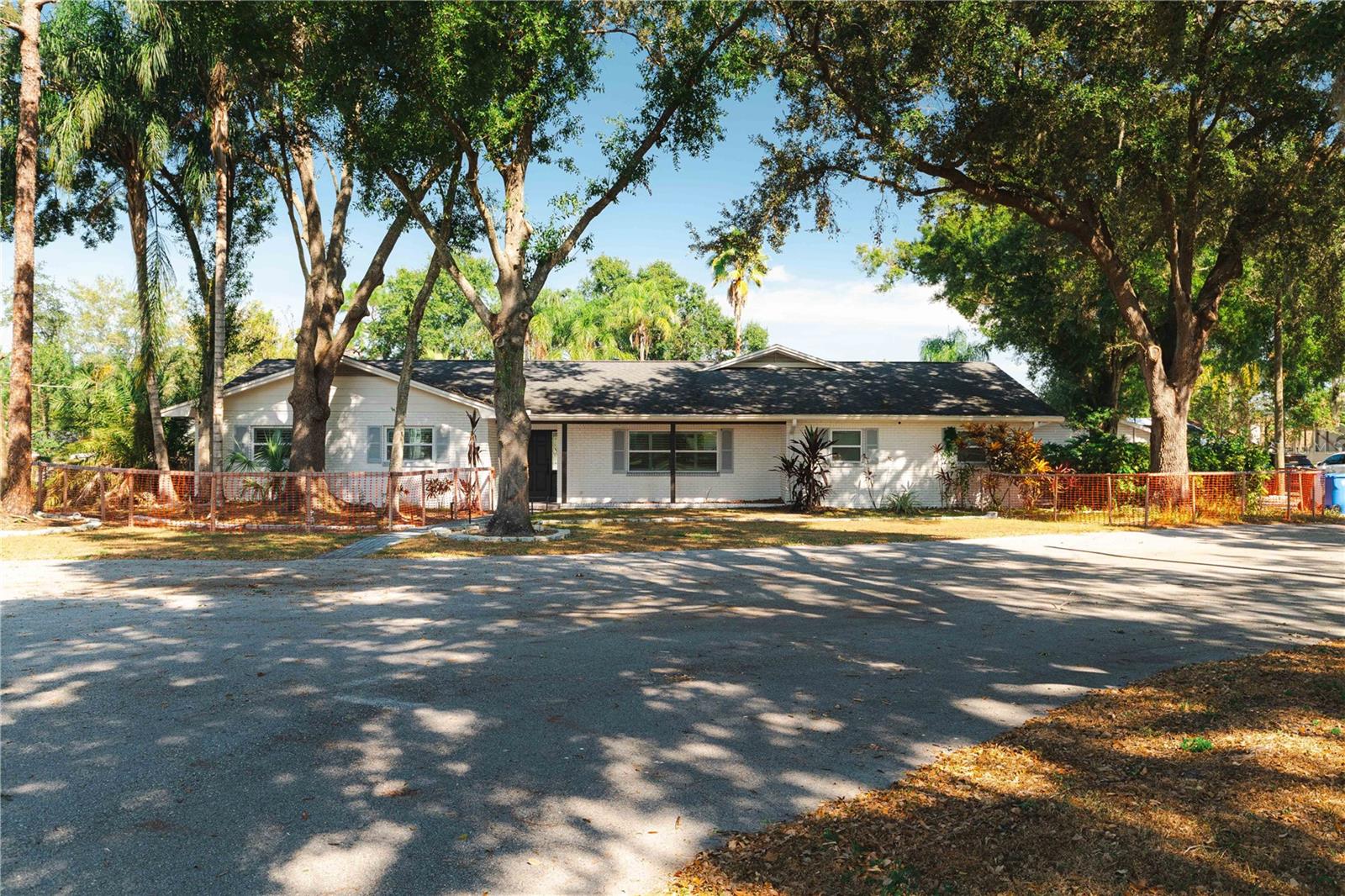 Welcome to 15509 Casey Road—a property that embodies opportunity, versatility, and vision in the heart of Carrollwood, one of Tampa’s most desirable and established neighborhoods. More than just a home, this estate is a unique combination of modern comfort, income-producing flexibility, and future development potential—offering a lifestyle and investment unlike any other.  Originally built in 1972 and thoughtfully renovated in 2021, this 4-bedroom, 3-bath pool home showcases the warmth of traditional design infused with quality updates and modern functionality. Step inside and discover a bright, open layout enhanced by oak hardwood flooring throughout, granite countertops, custom hardwood cabinetry, and stainless steel appliances including an LG stove, Whirlpool refrigerator, wine cellar, and wine rack. The kitchen flows seamlessly into inviting living areas, perfect for both family life and entertaining.  The home features a dedicated office, ideal for working from home, and a spacious family room/man cave with 9-foot ceilings, a wet bar, and access to the covered lanai overlooking the sparkling pool—creating an effortless indoor-outdoor flow. Every detail has been upgraded for comfort and style, including new doors, windows, ceiling fans, fixtures, and an outdoor kitchen with gas BBQ—perfect for Florida evenings spent with family and friends.  Beyond the main residence, this property includes two fully independent efficiency suites, ideal for multi-generational living, extended guests, or rental income.  Additional features include a two-car garage. Every inch of this property has been designed for functionality, comfort, and potential.  Yet what truly sets 15509 Casey Road apart is its exceptional development opportunity. The property comes with approved site development plans for seven single-family home lots, offering immediate potential for a new residential community. For builders and investors, this is a rare find—zoning and site approval are already in place, saving months of preliminary work. Even more valuable, the current owner has developed three distinct floor plans ready to propose for the project, making it easier to bring a cohesive and profitable vision to life.  Whether you envision this as a private retreat with income-producing units, a multi-home development, or a hybrid investment blending both, this property delivers endless flexibility. The location only enhances its appeal—just minutes from top-rated schools, major highways, shopping centers, restaurants, parks, and all the lifestyle conveniences Carrollwood is known for.  With its combination of move-in ready living, proven rental income, and pre-approved development potential, 15509 Casey Road represents an unparalleled opportunity for homeowners, investors, and developers alike. Don’t miss your chance to own a one-of-a-kind property where residential charm meets long-term growth and future vision in the heart of Tampa Bay.