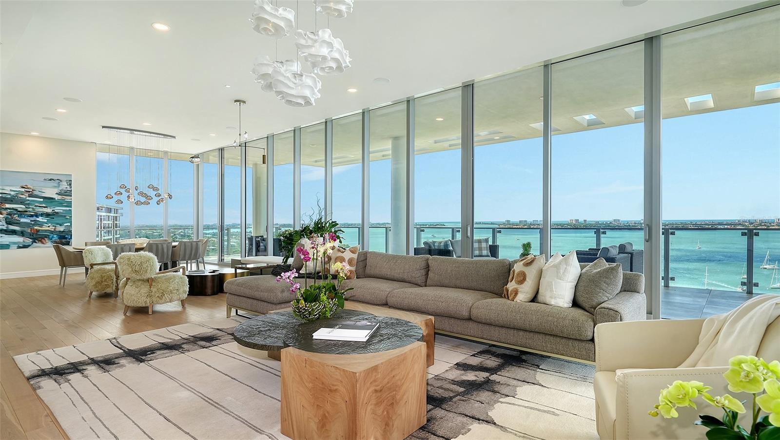 AN EPOCH OPPORUNITY IN SARASOTA. NOW $7.495M for endless views, downtown walkability and unparalleled service. Truly a rare chance to obtain such value for a full floor of "gorgeous" at Sarasota's most iconic address. One step inside, and you're enveloped in luxury, where architecture becomes art. Inspired by the Sarasota School of Architecture, architectural elements of Brise-Soleil produces beautiful light and ambiance unique to each of the 23 bespoke residences. This twelfth-floor masterpiece, built in 2021, provides almost 5,700 sq ft of interior space and nearly 2,000 sq ft of wraparound terraces - where panoramic views of Sarasota Bay and spectacular sunsets over the Gulf are an everyday experience. The custom design blends the highest level of craftsmanship with peace of mind - featuring enhanced hurricane construction complete with floor-to-ceiling 11.5 ft impact sliders - creating striking views with seamless indoor-outdoor living. Esteemed local designer, Studio G, curated this home with sophistication and warmth - an enveloping feel of comfort within modern design. Your private elevator entry offers a first glance of the custom features throughout - such as walnut feature walls and designer floating cabinets.  The gourmet kitchen boasts Gaggenau™ appliances, 5-burner gas cooktop, Quartz surfaces, built-in coffee/juice station, Italian-made cabinetry, custom walnut dining island and coordinating accent wall.  You'll have endless choices for dining and entertaining - outside with a grill, refrigerator & private seating area - or indoors with cool water views under a gorgeous Ochre™ hand-blown chandelier. Wine connoisseurs will love the 1600-bottle wine room and cozy tasting area just outside its doors. The primary suite features panoramic views of downtown on your private balcony, a walk-in closet & spa-inspired en-suite bathroom. Enjoy a truly Zen experience with a large soaking tub, custom dual floating vanities, Neolith™ porcelain panels and dual water closets. The three guest rooms enjoy ample walk in closets, en-suite bathrooms & impressive floor to ceiling city views, each with their own terrace. Among the standout features that elevate this residence to true luxury living are a hand-carved onyx powder room sink, a VRF commercial-grade air conditioning system, Control4 automation and an RWS™ home water filtration system. The property also includes a private three-car garage with an EV charger & generous storage space. Epoch provides world-class amenities: 24/7 security and concierge desk, Resident’s Club gathering room with bar, game tables, wifi & fireplace, a resort style 70-ft lap pool & spa with a summer kitchen, gas grills and fire tables. A dedicated mail and package area ensures secure deliveries, while a fitness center, massage suite, steam showers and a guest suite address all your expectations.  And don’t miss the unforgettable views from the rooftop terrace - with seating for sunset cocktails and stargazing. This location is both preferred and peaceful - as you can simply step outside for a short stroll to some of Sarasota's finest dining, shopping and art venues. Water activities are just across the street at Marina Jack and Bayfront Park - and experience the best views for annual fireworks in the comfort of your own home! There hasn't been a better time - or better value - for attaining THE Sarasota address that hits all the marks for luxury.