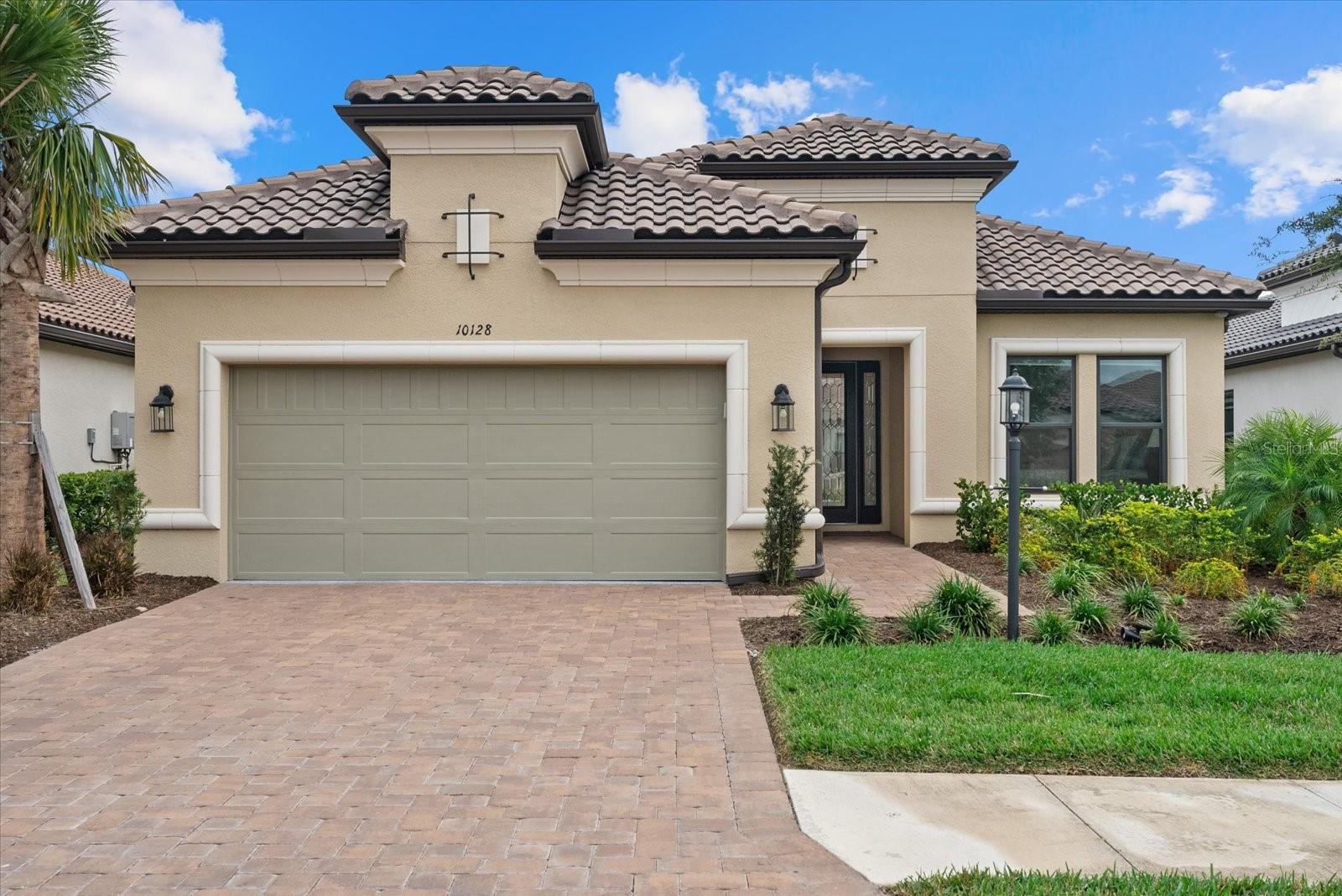 Price Reduction! Skip the wait and step straight into a highly refined, move-in-ready home in the sought-after Esplanade at Skye Ranch. On a quiet street, this lightly lived-in upgraded Lazio floor plan combines thoughtful design, upscale finishes, and effortless Florida living. Offering furnished 3 bedrooms plus a den, 3 full bathrooms, and a 3-car tandem garage. Inside, the home immediately stands out with designer-selected finishes and extensive upgrades throughout. Soaring ceilings, elegant tray ceiling details in both the living room and the primary suite, and sleek porcelain tile flooring. Custom crown molding adds a polished, finished feel to every room, while natural light enhances the open-concept design.  The kitchen is a true centerpiece, designed for both everyday living and entertaining. Quartz countertops, upgraded appliances, and beautiful wood cabinetry are complemented by a large island featuring an added sink and extra storage with upgraded cabinetry on the backside—making it as practical as it is stylish. A spacious breakfast nook with additional built-in cabinetry expands the kitchen even further.  The owner’s suite offers a beautiful bay window, tray ceiling, an oversized walk-in closet, and a spa-like bathroom complete with dual vanities and a generous walk-in shower.  Outdoor living includes an expanded spacious screened-in lanai, enhanced with electric roll-down hurricane shades for added protection and comfort.. Gutters have also been added along the front of the home, providing enhanced protection and long-term durability—an upgrade completed after construction.  Beyond the home itself, Skye Ranch delivers an unmatched lifestyle with resort-style amenities including multiple pools, tennis and pickleball courts, a modern fitness center, indoor basketball, miles of walking and biking trails, and vibrant social destinations such as The Hub, The Venue, Rendezvous Park, and Turner Park. Esplanade at Skye Ranch is more than just a place to call home, it’s a way of living.  This home has over $200,000 in upgrades and is a standout opportunity in one of Sarasota’s most coveted lifestyle communities—upgraded, move-in ready, and thoughtfully finished beyond new construction.
