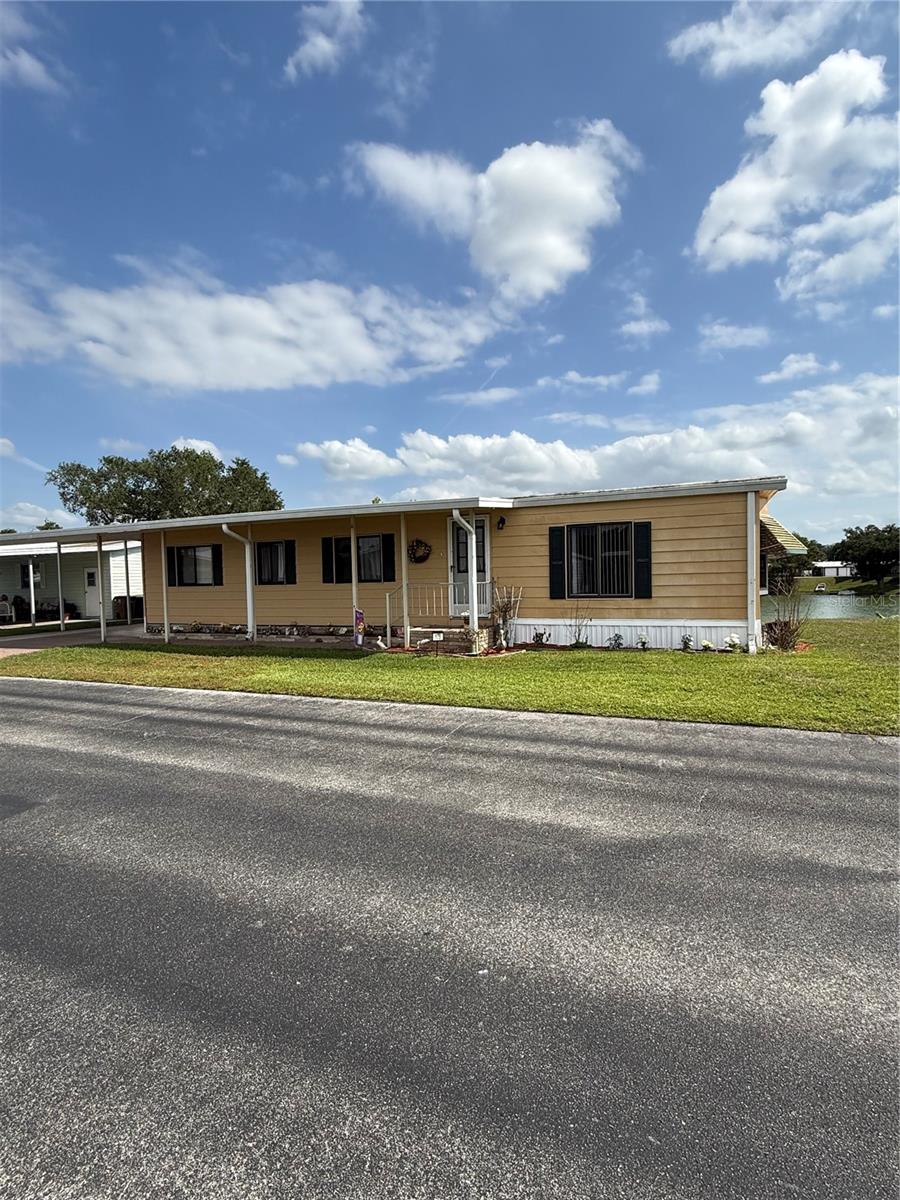 Move-in ready lakefront manufactured home in the highly desirable 55+ Floral Lakes community in South Bartow. This well-maintained 2-bedroom, 2-bathroom residence offers serene water views and a spacious Trex deck—perfect for grilling, relaxing, and enjoying the peaceful lakefront setting.

Inside, the home features a functional and inviting layout with custom built-ins in the dining area, providing both character and convenient storage. Recent upgrades include a new HVAC system and a newer roof, offering peace of mind for years to come. Most furnishings are included, making this an easy transition for seasonal or full-time living.

The exterior boasts several valuable improvements, including a newly built private dock, a one-car carport, an attached utility/storage room, and an additional workshop space—ideal for hobbies or extra storage needs.

Floral Lakes is a golf cart-friendly community known for its active lifestyle and welcoming atmosphere. Residents enjoy access to a clubhouse, heated pool, shuffleboard courts, putting green, and a variety of organized social activities. Additional community features include a stocked pond with a boat ramp and dock, as well as optional RV storage.

Conveniently located in Central Florida, this home provides easy access to major routes connecting Tampa and Orlando, while remaining close to local parks, a public library, civic center, and the charm of historic downtown Bartow.