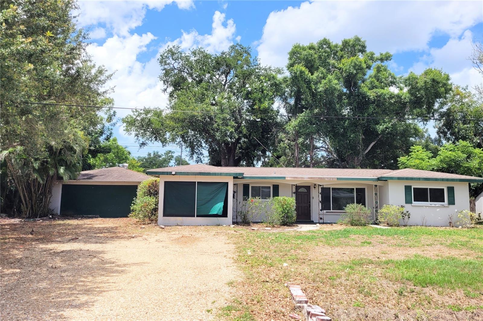 An excellent opportunity for buyers ready to create their dream home. Recent improvements include A/C (2018), hot water heater (2014) and updated windows (2013 & 2014). A NEW Shingle Roof will be installed by the Sellers prior to closing along with a Range in the Kitchen. This 3 Bedroom 1 Bathroom Split Plan Layout offers a rare opportunity to own a spacious home situated on an oversized double lot of 15,485 SF with NO HOA or deed restrictions — bring your boats, RVs, trailers, and recreational vehicles! The property offers exceptional storage and versatility with both an attached oversized 2+ car garage of 621 SF (27x23) and 2 car detached garage of 676 SF (26x26), plus an additional storage closet off of the attached garage (5x16) and an outdoor shed ideal for tools, hobbies, or outdoor equipment. Enjoy Florida living year-round from the large 220 SF screened lanai, offering plenty of room for entertaining, lounge seating, or even a future spa setup. Conveniently located just minutes from shopping, downtown Sarasota, Gulf beaches, dining, and local parks, this property combines privacy, flexibility, and prime location. Owned by only two owners since 1980, this home is filled with potential and ready for its next chapter. Don’t miss this unique opportunity to transform a well-located property with endless possibilities!