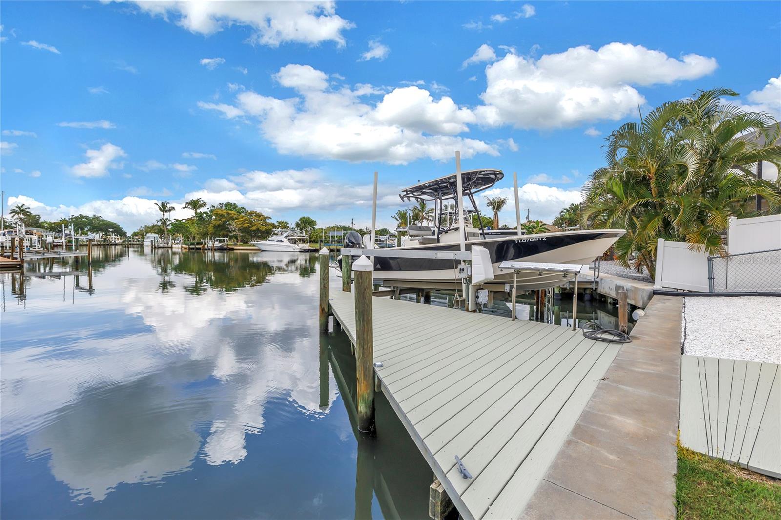 Welcome to luxury waterfront living in the highly desirable Bay Colony community at 4911 Palmetto Point Drive. Conveniently located just minutes to I-275, I-75, and US-41 and approximately 15 minutes to vibrant downtown St. Petersburg, this exceptional deep-water estate did not take on any water during the recent storms!!  This one of a kind home offers breathtaking straight-channel views, incredible privacy, and direct access to the ultimate Florida boating lifestyle. Meticulously maintained and showcasing true pride of ownership inside and out, this expansive residence features over 2,600 sq ft of living space with 3 bedrooms, 2 full bathrooms, 1 half bath, and a dedicated office.
Designed to maximize its stunning waterfront setting, the home offers spacious living areas filled with natural light and stunning water views throughout. The open and inviting floor plan flows seamlessly to the outdoor living space where a beautiful pool and spa overlook the most AMAZING channel view!!. Enjoy daily visits from dolphins and manatees right from your private dock while taking advantage of some of the deepest water in the community.
Perfect for boating enthusiasts, the private dock currently accommodates an 8,000 lb boat lift and can easily be modified for a 10,000 lb lift, offering quick access to the Manatee River, Tampa Bay, and Gulf waters. This property also features a 2-car garage plus a separate 1-car/boat carport and includes a 2023 jet ski with less than 30 hours of use.
Additional highlights include no HOA, a private community boat launch available for a nominal fee, mature tropical landscaping, and exceptional outdoor entertaining space.
This rare waterfront opportunity combines luxury, boating, convenience, and an unbeatable coastal lifestyle in one extraordinary property.
