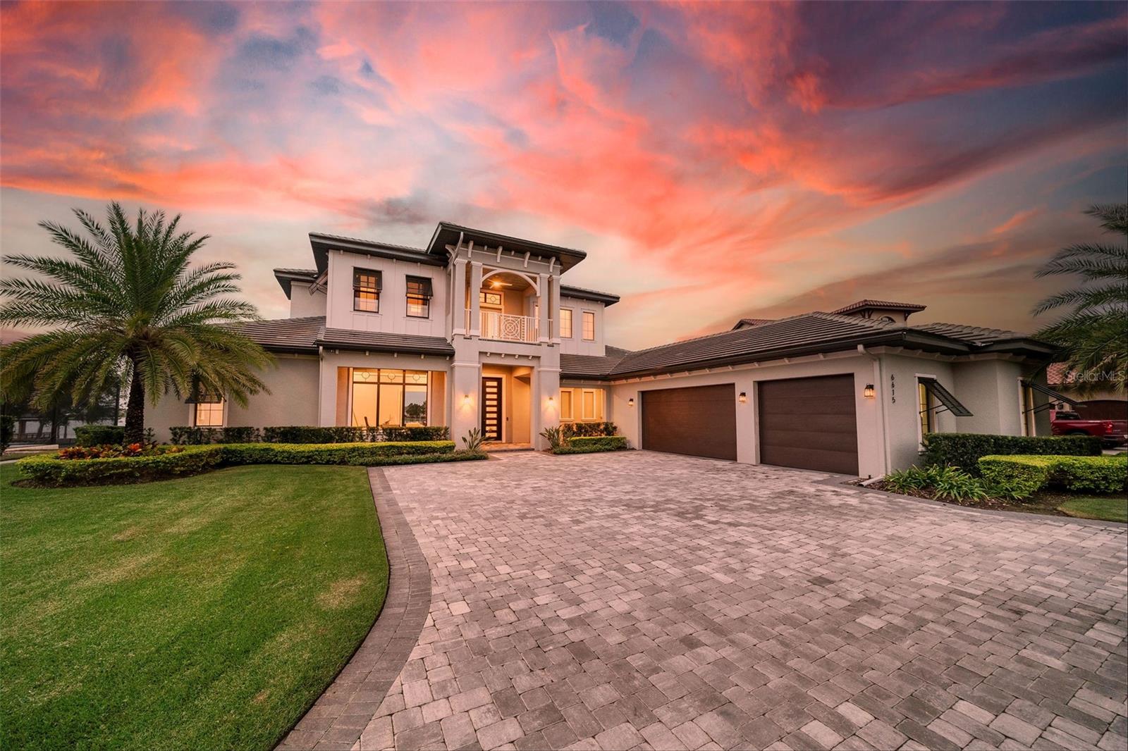 Experience the epitome of luxury living in this 2019 custom-built contemporary masterpiece by Davila Homes along the pristine shores of Lake Hancock, renowned as one of Central Florida's most coveted ski lakes. Boasting four bedrooms, five-and-a-half bathrooms, a dedicated office, and a bonus room, this residence seamlessly blends modern design with the tranquility of lakeside living.  

Step inside to discover an open, sunlit space connecting the living room, dining area, and chef's kitchen. Expansive windows frame panoramic lake views, creating an inviting atmosphere throughout. The owner's bedroom, complete with a custom walk-in closet, provides comfort and convenience. Additional features include a dedicated office on the main level and an entertainment center on the second floor, opening to a patio with stunning lake vistas.

Beyond the ordinary, this home features a gym (4th bedroom) with expansive windows, surround sound throughout the home, a whole house water softener and filtration system, and an oversized laundry room that includes modern amenities, including a pet wash station.  

The floor-to-ceiling stackable sliding doors allow you to step outside to your private paradise with phantom screens, an infinity-edge saltwater pool with a fire bowl, a spa, and a chef's dream outdoor kitchen. Enjoy a low-maintenance turf yard, ensuring lush greenery year-round. The pièce de résistance? Witness enchanting Disney Fireworks from the comfort of your backyard.

As part of a vibrant community, residents enjoy access to a 5,000 sq ft Resident's Club, featuring a state-of-the-art fitness center, business center, arcade, resort-style pool, and playground.

Conveniently located just minutes from the Hamlin Center and 429, this residence offers a perfect blend of serenity and accessibility. 

Don't miss the chance to call this lakefront haven home. Contact us now to schedule your private tour and embrace the luxury of Florida living.