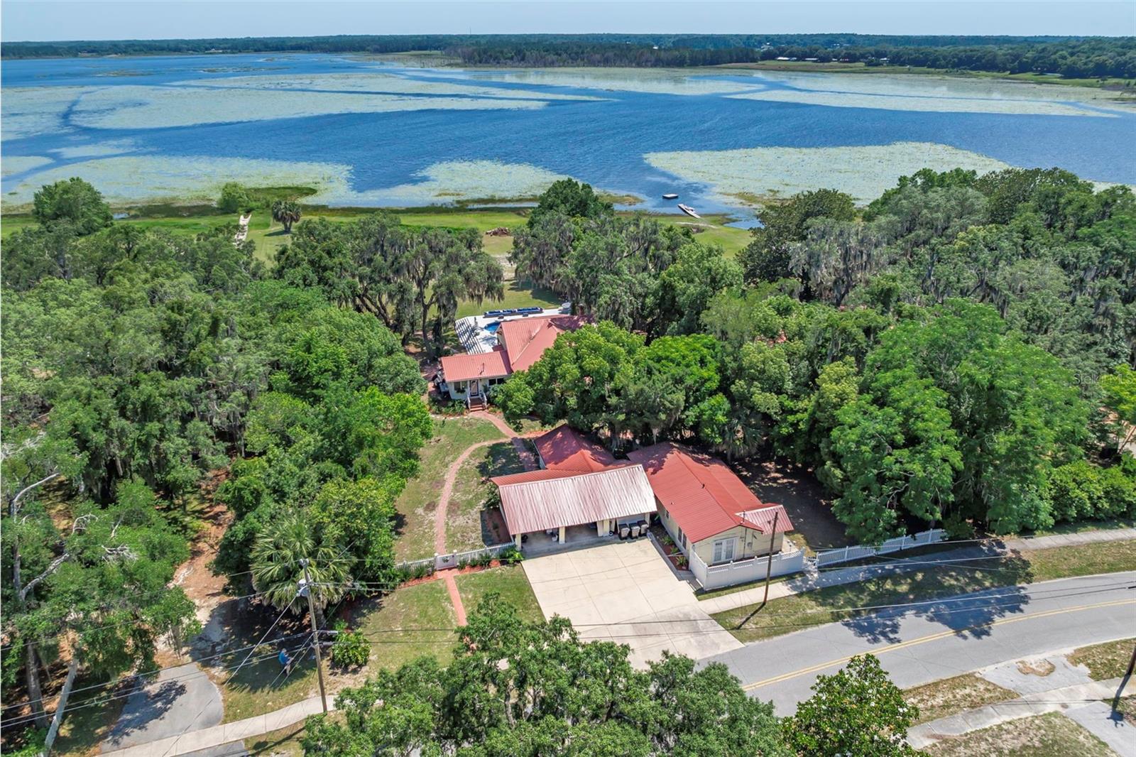 PRICED BELOW APPRAISED VALUE! With a recent appraisal this lakefront home is ready for summer fun and a great investment. Truly a must see property with vintage appeal and modern versatility. Imagine waking up every day to your lakefront estate situated on over an acre with an ADU for in laws or an income producing property. This home is located on one of the most prestigious lakes in Keystone Heights! Keystone is a community in North Central Florida seeped in history and reminiscent of stepping back into a Mayberry like town where neighbors become friends. The Keystone Beach, parks, a walkable downtown and "A" Rated schools are just two blocks away! If you're looking for a move in ready home with NO HOA and where everything has been already beautifully updated with a designer aesthetic this is the one! The floor plan in the main house gives you two bedrooms upstairs both with en suites and two bedrooms downstairs plus another bathroom and a office. In the detached guest house or ADU there is a full bath, spacious bedroom with walk in closet, a full kitchen, living room and a charming front porch to view your private and separate fenced in yard. The photos are gorgeous but the home shows even better! You have just found your oasis! Don't wait this home is exceptional.