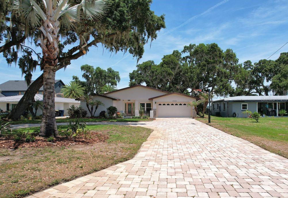 Welcome to lakefront living on beautiful Lake Ariana in Auburndale! This spacious 4-bedroom, 3-bath home offers over 3,000 square feet on more than half an acre and not in a flood zone! The home boosts a desirable split floor plan, oversized living room, separate family room and plenty of room for entertaining. Enjoy breathtaking views and an oversized backyard leading directly to the water and a brand new private boat dock! Conveniently located near the newly redesigned Lake Ariana Park and Civic Center, offering recreation, playground, and community amenities just minutes away. Home is situated on a separate access road adjacent to a main roadway for convenient access.
New roof at closing!