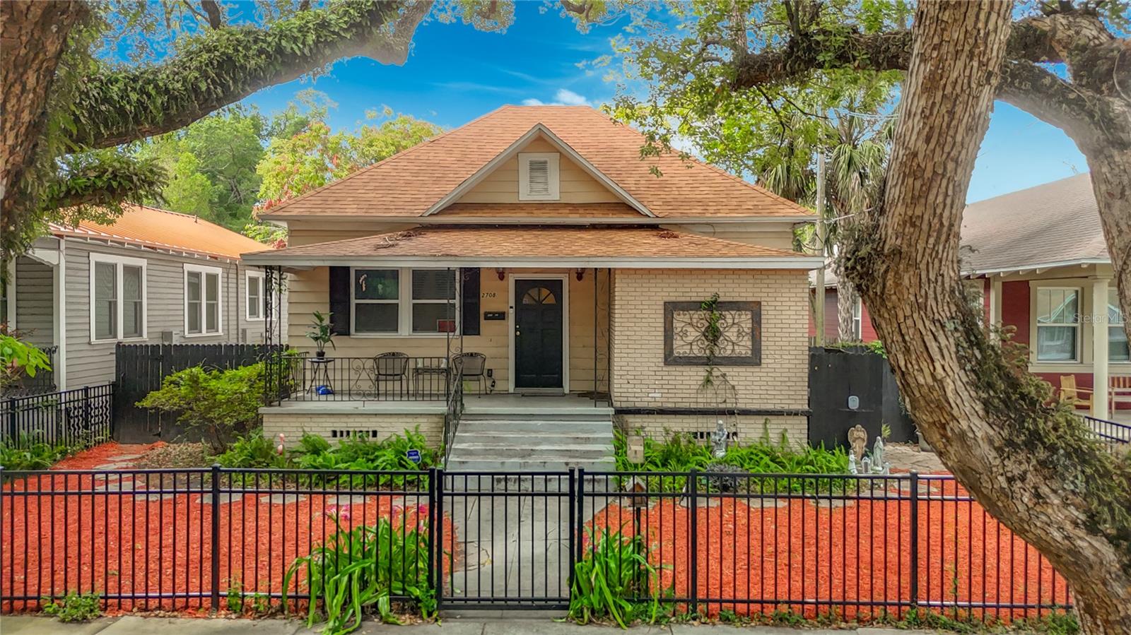 Historic Tampa Heights Charm Meets Modern Convenience in the Heart of Downtown Tampa. Welcome to 2708 N Jefferson Street, a beautifully maintained 1900 bungalow nestled in the highly sought-after Tampa Heights neighborhood. Situated on a generous 0.19-acre lot with valuable alley access, this 3-bedroom, 2-bathroom residence offers 1,388 square feet of character, comfort, and endless potential just minutes from Downtown Tampa. From the moment you arrive, you'll be captivated by the home's timeless curb appeal, highlighted by a welcoming front porch, mature camphor  tree canopy, and classic architectural details that reflect Tampa Heights' rich history. Inside, soaring ceilings, spacious living areas, and an open-concept layout create a bright and inviting atmosphere perfect for everyday living and entertaining alike. The thoughtfully designed floor plan features a spacious living room that flows seamlessly into the dining area and kitchen, complete with solid wood cabinetry, granite countertops, breakfast bar seating, and ample storage. The split-bedroom design provides privacy, while the flexible bonus room offers endless possibilities as a home office, library, reading room, or creative space. The primary suite is generously sized and complemented by a full bathroom, while two additional bedrooms provide comfortable accommodations for family and guests. Tile and wood flooring throughout add warmth and durability. Step outside to discover a private backyard retreat featuring mature tropical landscaping, a firepit gathering area, and a brand-new storage shed installed in 2025. The oversized lot and alley access create exciting opportunities for future expansion, additional parking, an accessory dwelling unit, or outdoor entertaining spaces. Major updates include a brand-new roof installed in 2025 and a new shed added in 2025, providing peace of mind for years to come. Located in Tampa Heights, one of Tampa's most desirable historic neighborhoods, residents enjoy quick access to Downtown Tampa, the Tampa Riverwalk, Water Works Park, Armature Works, Ybor City, Channelside, Water Street Tampa, and the city's vibrant dining, entertainment, and cultural scene. Tampa Heights continues to attract homeowners seeking a unique blend of historic charm and urban convenience.  Whether you're searching for a primary residence, investment property, or future redevelopment opportunity, this historic gem offers exceptional value in one of Tampa's fastest-growing neighborhoods.