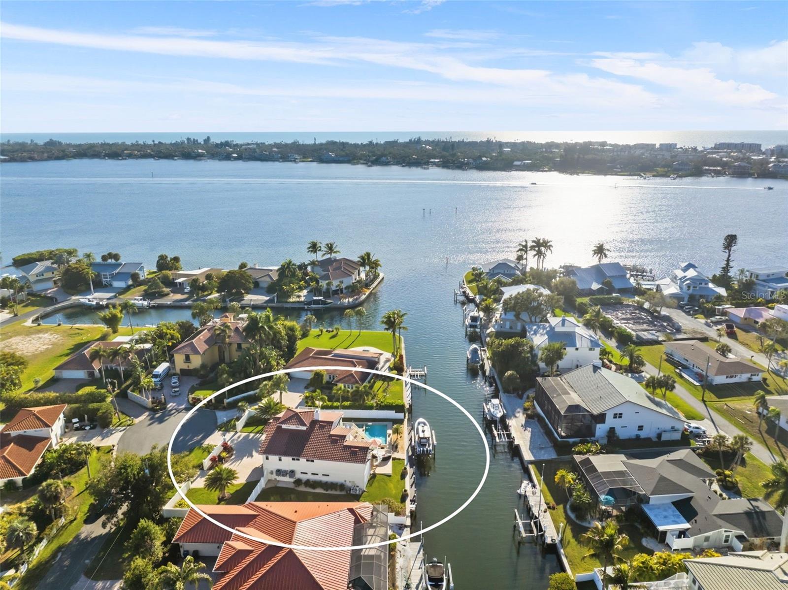 Welcome to 1725 Baywood Drive — an extraordinary waterfront estate ideally positioned just moments from open bay access in one of Sarasota’s most sought-after boating communities. Offered fully furnished, this exceptional residence delivers the ultimate blend of sophisticated coastal living and effortless luxury, allowing you to move in and immediately experience the Sarasota lifestyle at its finest. From the moment you arrive, lush tropical landscaping, a grand circular driveway, and elegant architectural presence create an unforgettable first impression. Inside, sun-drenched living spaces showcase timeless design, refined finishes, and an effortless flow ideal for both intimate living and upscale entertaining. Designed to maximize indoor-outdoor living, the home opens to a spectacular private waterfront oasis featuring panoramic water views, a resort-style pool and spa, expansive entertaining areas, and a fully equipped outdoor kitchen. Whether enjoying peaceful mornings by the water or hosting unforgettable sunset gatherings, every detail was thoughtfully crafted to embrace the beauty of Florida waterfront living. For boating enthusiasts, the private dock and 20,000-pound boat lift provide fast, direct access to Sarasota Bay and the Gulf of Mexico — making spontaneous days on the water effortless. Perfectly located just minutes from Siesta Key Beach, Southside Village, downtown Sarasota, and world-class dining, shopping, and entertainment, 1725 Baywood Drive offers a rare opportunity to own a true Sarasota waterfront retreat where luxury, privacy, and lifestyle come together seamlessly.