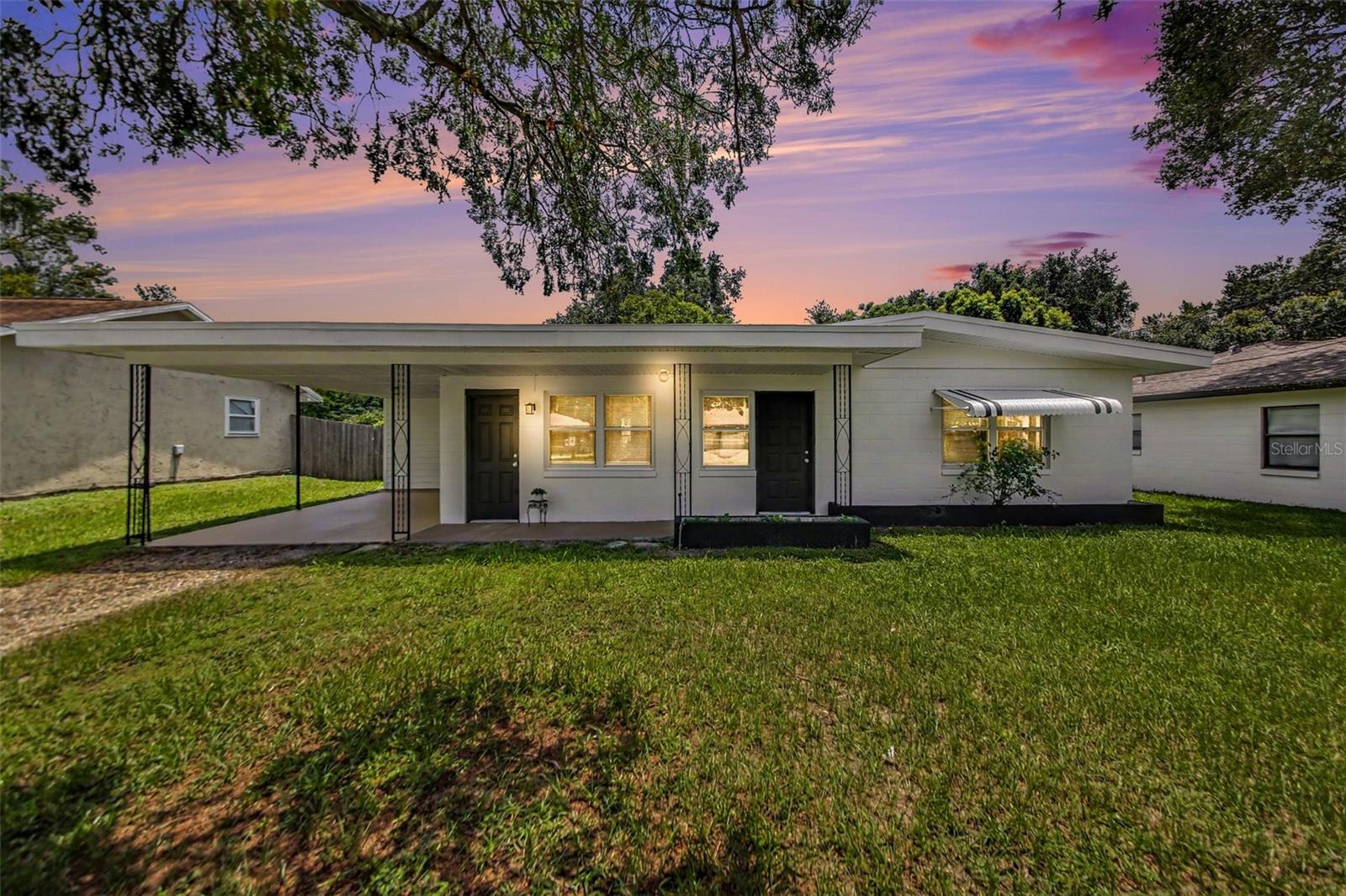 Updated Winter Park home with major improvements already completed and no HOA! Located at 4965 Orange Ave., this move-in ready property offers a desirable Central Florida location with convenient access to shopping, dining, parks, major roadways, and everything the Winter Park area has to offer. Recent updates include a NEW Roof, Dual-pane, Energy-efficient Windows, 2 NEW A/C systems, fresh interior and exterior paint, upgraded baseboards, Beautifully Remodeled Bathrooms, and terrazzo & ceramic tile flooring throughout (no carpet!!). The galley-style kitchen features stainless steel appliances, a decorative backsplash, and an efficient layout designed for everyday functionality. Both bathrooms have been beautifully refreshed, while the durable flooring and fresh finishes create a clean, cohesive feel throughout the home. Outside, the large fenced yard provides excellent outdoor space for entertaining, gardening, pets, or future possibilities. The attached carport includes a convenient storage and laundry room for added practicality. With no HOA, updated major systems, energy-efficient windows, and a centrally located Winter Park address, this home is an excellent opportunity for buyers searching for an updated home in Winter Park, FL with modern improvements, low-maintenance features, and easy access to the Greater Orlando area.