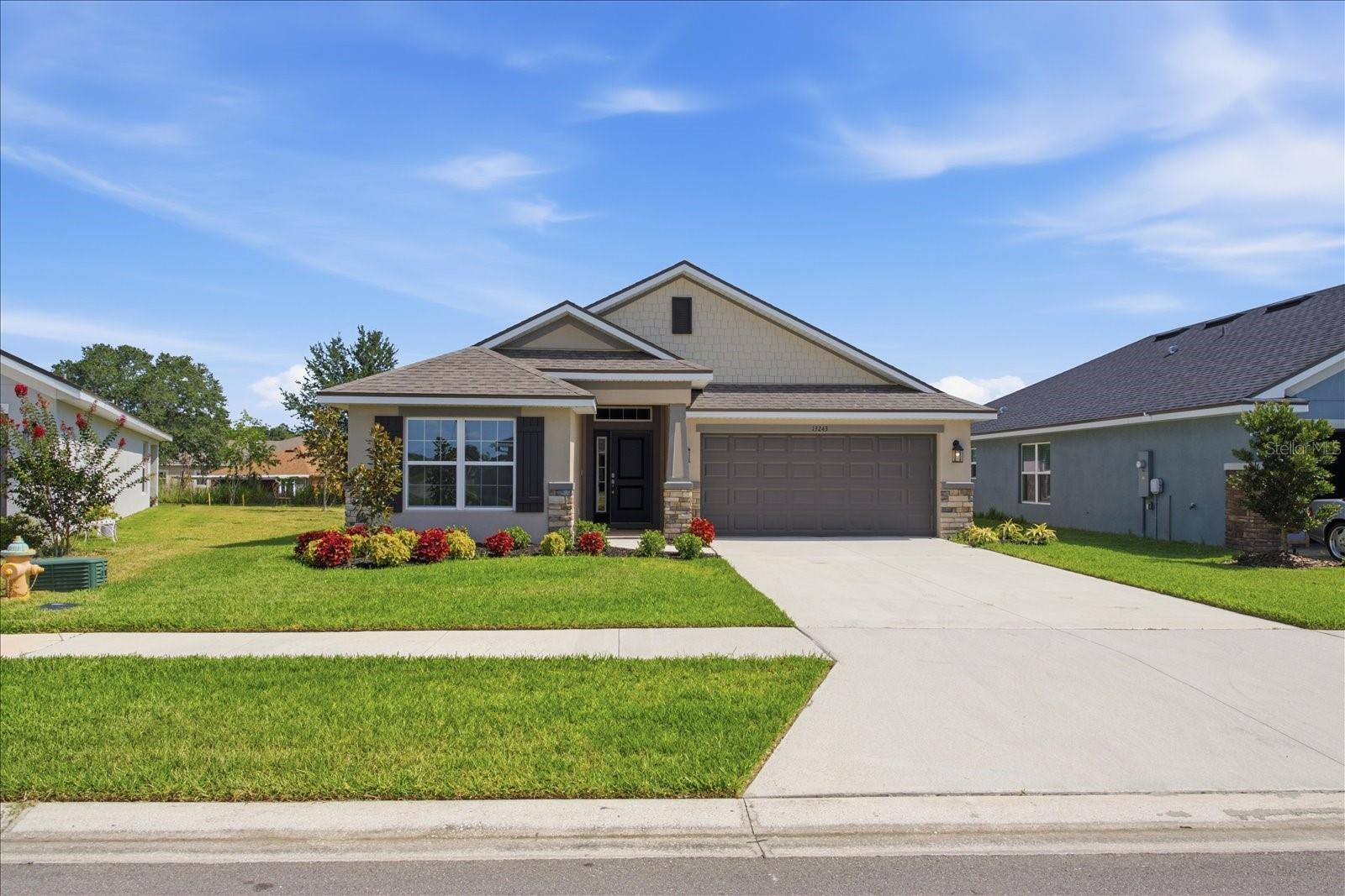 Why wait to build when you can move right into this beautifully maintained, nearly new home and save thousands compared to purchasing new?  Located in the growing Dade City community of Abbey Glen, this thoughtfully designed 3-bedroom, 2-bath home offers 1,720 square feet of stylish, open-concept living with the upgrades today's buyers are looking for—at a price that's hard to beat.  The spacious kitchen is truly the heart of the home, featuring custom 36-inch soft-close wood cabinetry, granite countertops, stainless steel appliances, a OneTouch gooseneck faucet, and a large breakfast bar that overlooks the great room, making it perfect for entertaining family and friends.  
The private owner's suite provides a relaxing retreat with a luxurious ensuite bath complete with dual granite vanities, soft-close cabinetry, a beautifully tiled walk-in shower with glass enclosure, and generous closet space.  Throughout the home you'll appreciate quality finishes including tile flooring throughout the main living and wet areas, elegant 5¼-inch baseboards, and upgraded 5-panel interior doors that add a custom feel. An in-wall pest control system offers added convenience by allowing exterior treatment without introducing chemicals into the living space.  Outside, enjoy the peace of mind that comes with newer construction while avoiding the higher price tag of nearby new builds. With comparable homes in the neighborhood selling for more, this home represents an exceptional opportunity to enjoy modern construction, energy efficiency, and move-in-ready convenience—all while keeping more money in your pocket.  If you've been considering new construction, be sure to compare this home before making your decision. You may find everything you've been looking for...for significantly less.