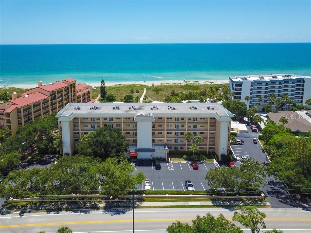 Rarely available top-floor 2-bedroom condominium offering truly spectacular, million-dollar water views. Bay Tree Club is a gulf-to-bay property that  provides the perfect Florida lifestyle. Enjoy breathtaking scenery of the Gulf from the comfort of your home while embracing the ultimate waterfront  living.    Gulf side has storage cabanas for your beach umbrella, chairs and bikes with secure restroom facilities just off the beachside path.  For BOATING ENTHUSIASTS, this property is a RARE FIND! Easy access to the newly reopened Midnight Pass! Boat slips are just steps from your door on the Bay side. Year round moorings to the TREX dock at no charge. Convenient access to the Gulf along with free electricity and water. A floating dock or lift can also be added.   Whether you're heading out for a day on the bay, enjoying sunset cruises, or simply appreciating the waterfront setting, this condo offers the perfect combination of comfort, convenience, and coastal living. Complex has two heated pools to provide the perfect spot for sunning or doing your laps. This condo was renovated to provide an open plan with IMPACT WINDOWS, UPDATED BATHS, TANKLESS HOTWATER HEATER, and IN UNIT LAUNDRY.  In addition to the in unit laundry there is a laundry on all levels, elevator, full-time maintenance and onsite manager.  The kitchen flows seamlessly into the dining/living combination.  But the real living takes place from morning till sunset in the enclosed 14' X 8' loggia that can accommodate for cocktails, bridge, or just relaxing as the sun sets over the gulf horizon. Contiguous ceramic tile floors throughout, set diagonally add to the open feeling. Many cabinets and drawers in this kitchen with a breakfast island.  Plenty of counter space covered in classic black granite.  The guest room has its own ensuite bath and a Murphy Bed hidden behind a moving bookshelf should an office be needed. Conveniently located near the free trolley stop, you’ll have easy access to explore Siesta Village’s restaurants, shops, and the world famous Siesta Key Beach.  The Siesta Key Trolley travels right by the front door 7 days a week from 10-10 and until midnight on weekends to make a trip to the Siesta Key Village easy and convenient.  Unit comes furnished!