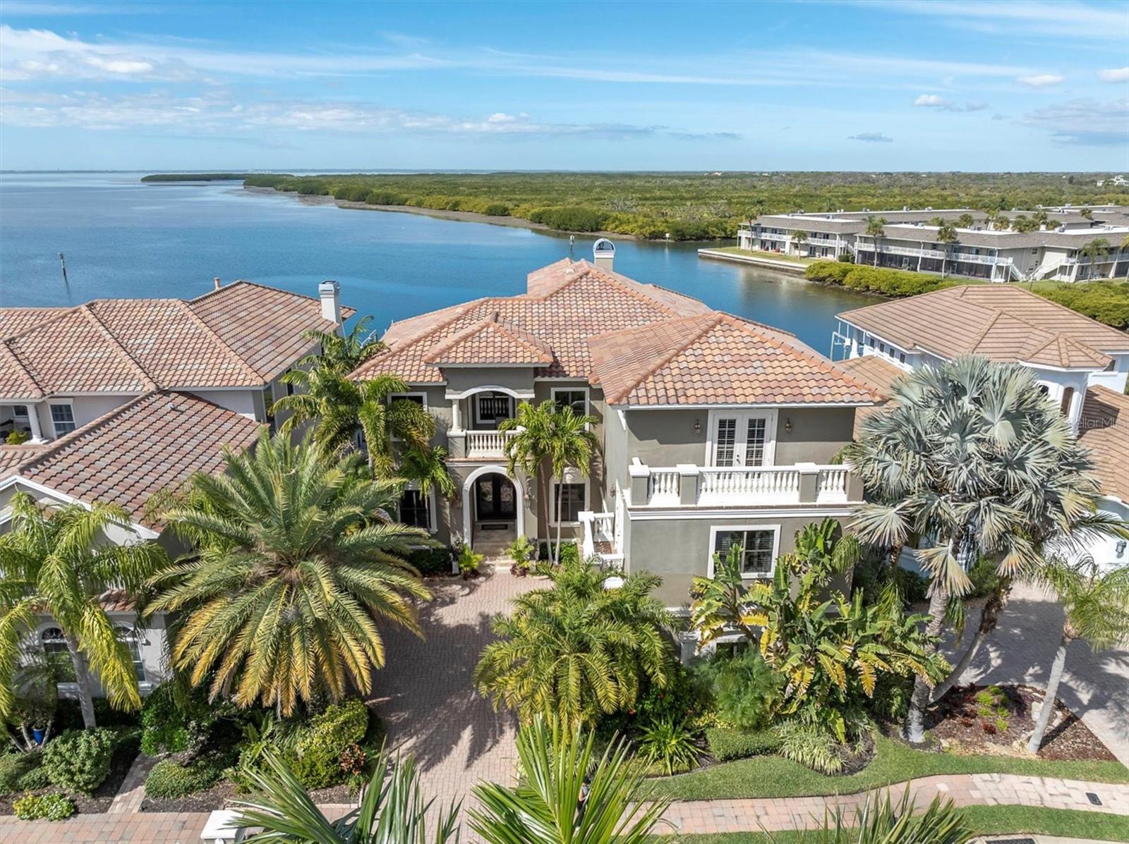 Welcome to 4118 Causeway Vista Drive, a magnificent waterfront estate located in the gated community of The Reserve of Old Tampa Bay. This luxurious property offers an unparalleled combination of elegance, comfort, and stunning bay views, making it a true haven for those seeking the g. Walking up the steps to the commanding front doors you realize this home is truly a sanctuary combining luxury,
relaxation, and entertainment. Once inside you’re drawn to the formal living room that captures stunning bay views. These views continue
through the family room that has a beautiful wood tray ceiling, custom built-in cabinetry, and cozy gas fireplace, creating a warm and inviting ambiance. The tray ceiling extends into the Tuscan designed kitchen equipped with a six-burner gas cooktop with custom hood, built-in oven, matching cabinet-faced refrigerator, butler’s pantry with bar refrigerator, large island with prep sink, walk in pantry, and a spacious dining area. Those special dinners will be celebrated in the formal dining room that exudes elegance with the copper ceiling and stunning chandelier. The first level also offers a study that showcases beautiful built-in bookshelves and tin ceiling, creating an inviting atmosphere for work or leisure. The second level begins as you make your way up the amazing staircase enhanced with iron spindles. Here you’ll find the primary suite. This private retreat uniquely features two levels with panoramic bay views. The large ensuite entails a walk-in shower, jetted soaking tub, and double vanities. Additionally, it offers two walk-in closets with custom shelving, sitting area, gas fireplace, and an office in the crow's nest with a balcony, where you’ll encounter amazing sunsets. Each of the other bedrooms in the residence are thoughtfully designed and offers its own unique features. The fifth bedroom is a very private space and currently used as a gym. It would make the perfect guest room or in-law suite. There’s also a massage room with a balcony perfect for unwinding after a long day at work, which could also be used as a second office space if needed. For those who appreciate the magic of cinema, the theatre room located on the third level has elevated seating and is ideal for hosting movie nights and creating unforgettable experiences. This large room has beautiful built-in cabinetry and a billiards table for an added bonus. The expansive pool area is one of many highlights this home captures for your outdoor enjoyment. It’s the epitome of outdoor living. Spend your days basking in the Florida sunshine or cool off with a refreshing swim while enjoying the tranquil waterfront backdrop. The outdoor kitchen is equipped with everything you need for hosting memorable gatherings and dining under the stars. Water enthusiasts will rejoice in the presence
of not one, but two boat lifts, offering convenient access to the bay and making it effortless to embark on boating adventures. Explore the
beautiful Tampa Bay area, go fishing, or simply enjoy a leisurely cruise along the scenic coastline. The possibilities are endless for those who appreciate the allure of waterfront living. Don't miss the opportunity to make this waterfront retreat yours. Contact us today to schedule a private viewing and experience the exceptional waterfront lifestyle that awaits you at 4118 Causeway Vista Drive.