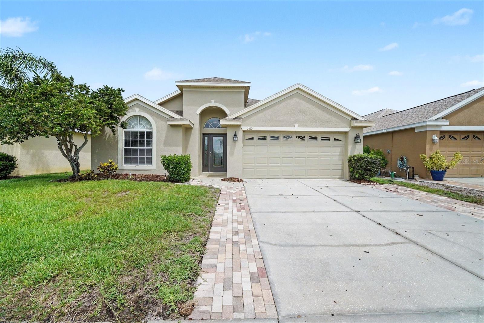 Virtually Staged. Welcome to the highly desirable Key Vista community, where resort-style amenities and comfortable living are at your doorstep! This beautifully maintained home offers outstanding curb appeal with attractive paved stone accents and a thoughtfully designed floor plan featuring low-maintenance luxury vinyl plank and tile flooring throughout.

Inside, you'll find a spacious kitchen equipped with stainless steel appliances, rich maple cabinetry, and plenty of room for everyday dining and entertaining. Oversized bedrooms provide comfort and flexibility, while the private primary suite features a walk-in closet, dual sinks, and a relaxing ensuite bath with a separate soaking tub and walk-in shower.

Enjoy Florida living year-round from the screened-in patio overlooking a private backyard which is perfect for morning coffee, outdoor dining, or simply unwinding at the end of the day. An attached 2-car garage offers ample parking and storage space.

Residents of Key Vista enjoy access to exceptional community amenities, including a clubhouse, fitness center, swimming pool, tennis courts, and park areas. Conveniently located near shopping, dining, schools, and Gulf Coast attractions, this move-in-ready home offers the perfect blend of comfort, convenience, and community living. Don't miss your opportunity to make this beautiful home yours!