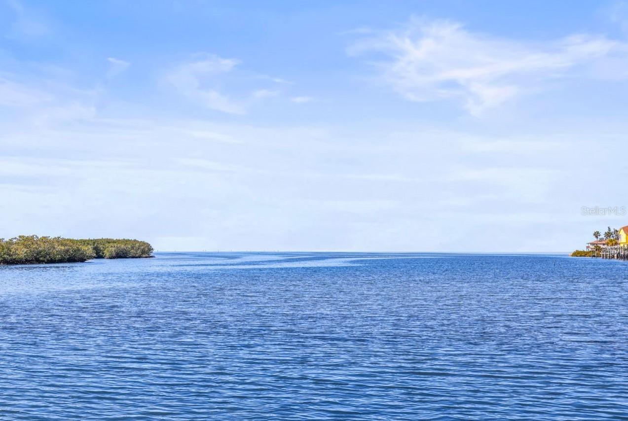 On the Gulf, this one-of-a-kind residential lot offers a truly unique location in a naturally protected Gulf bay, sometimes visited by dolphins and manatees. The cleared lot features wide, open, unobstructed full-water views with direct Gulf and ocean access, along with western exposure for spectacular sunsets, panoramic vistas, and refreshing sea breezes. Ideal for fishing, birding, boating and all water sports. Special lot features include a full-length reinforced structural concrete seawall complete with a wide structural concrete cap and concrete davit mounts for boat lifting. The property is also located by the Gulf Channel, allowing excellent navigation to the nearby Port of Hudson and access for larger boat docking. Situated in the highly desirable Driftwood Isles Residential District, this lot includes paved road access, available water, sewer, and all public utilities, with no HOA fees. The lot is clear and ready for construction. Located on a paved, private, and tranquil McDonald Lane in Hudson, Florida, away from congestion yet very close to Hudson Beach Marina and other beaches. Conveniently near the Regional Medical Center, community hospital, medical plaza, healthcare facilities, nursing homes, social services, regional libraries, schools (including elementary, middle, and high schools), colleges and universities, shopping, restaurants, golf courses, country clubs, parks such as Veterans Memorial Park, Aripeka Sandhills Preserve, and Robert J. Strickland Memorial Park. Also conveniently located near Tampa International Airport, Disney, and other major attractions.