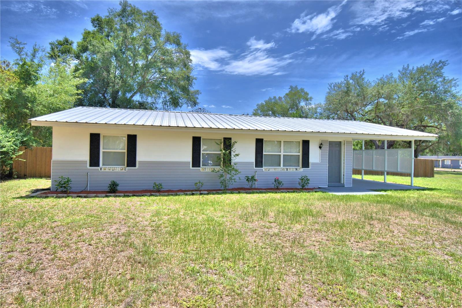 Located in a well-established neighborhood in Fort Meade, this beautifully maintained 3-bedroom, 1-bath home offers comfort, functionality, and plenty of outdoor space. The spacious living areas flow seamlessly to a large porch, creating the perfect spot to relax, entertain, or enjoy Florida living year-round.
The updated kitchen is designed with both style and practicality in mind, featuring a center island with butcher block countertops, IKEA cabinetry, and an abundance of storage space. The kitchen flows effortlessly into the dining area, creating a welcoming space for everyday living and gatherings with family and friends.
The home's three-bedroom layout offers comfortable accommodations for family and guests. The large primary bedroom offers a walk-in closet and ample space for a king-sized bed and additional furniture. 
Situated on a large lot, the property features a fully fenced backyard with a custom-built wood privacy fence, providing plenty of room for pets, play, gardening, and outdoor activities. Double gates on both sides of the home offer convenient access for storing a boat, trailer, recreational vehicles, work equipment, or other outdoor toys. An impressive 12' x 40' Smithbilt shed with electric provides exceptional storage space and endless possibilities for a workshop, hobby area, or equipment storage.  The climate-controlled laundry room is conveniently located just off the carport, adding comfort and functionality to everyday living.
This home has been exceptionally cared for and includes numerous updates for peace of mind, including a metal roof.  The new air conditioning system and ductwork was installed in January 2026.  Additional improvements completed in recent years include replacement windows throughout the home and updated plumbing.  Move-in ready and packed with valuable upgrades, this property offers the perfect combination of indoor comfort, outdoor space, and practical features. Don't miss the opportunity to make this well-maintained Fort Meade home your own.
