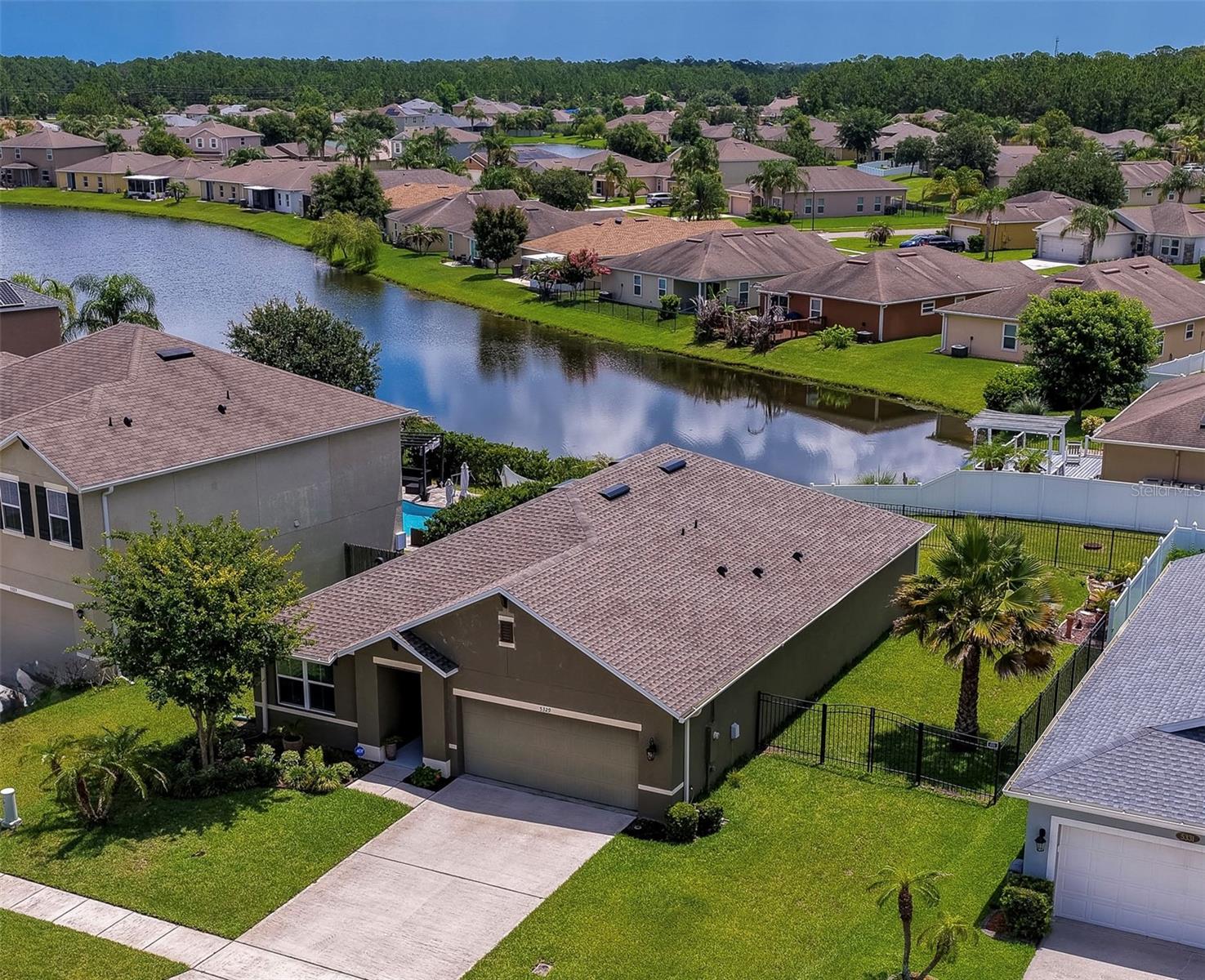 Updated Lakeview home in the desirable Port Orange Plantation community. Built in 2018 and featuring numerous recent improvements, this 3- bedroom, 2-bathroom home combines modern finishes, open-concept living, and serene water views. New roof! Freshly painted inside and out, the home welcomes you with an inviting foyer, decorative archways, and a spacious layout designed for comfortable everyday living and entertaining. The updated kitchen showcases white shaker-style cabinetry, quartz countertops, new stainless steel appliances, a large center island with seating, and a walk-in pantry. The open-concept design seamlessly connects the kitchen to the dining and living areas, creating an ideal space for gatherings. The generous primary suite offers a relaxing retreat with luxury vinyl flooring and an updated en-suite bath featuring a double-sink vanity with quartz countertops and an oversized walk-in shower with glass enclosure. Two additional bedrooms provide flexibility for family, guests, or a home office, while the guest bath features an updated vanity with quartz countertops and modern finishes. Outdoor living is equally impressive with a spacious screened lanai and newly installed screen enclosure overlooking the fully fenced backyard and peaceful lake views. The new jacuzzi creates the perfect setting to relax and unwind while enjoying the tranquil waterfront backdrop. The aluminum-fenced yard offers ample space for outdoor activities, pets, gardening, or simply enjoying the Florida lifestyle. The attached 2-car garage provides additional storage and convenience. Located in a prime area, this home is just minutes from the Pavilion, Coraci Sports Complex, shopping, restaurants, entertainment, medical facilities and easy access to I-95.  Plus, you're just a short drive from the beautiful beach. All information recorded in the MLS is intended to be accurate but cannot be guaranteed.