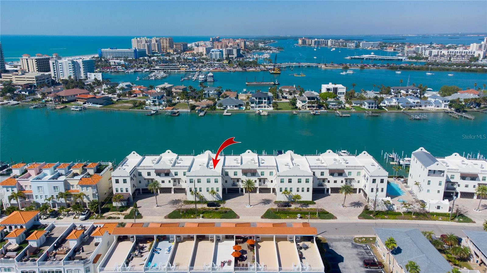 Experience the pinnacle of waterfront living in this stunning three-story end-unit townhome, offering 2,794 square feet of beautifully designed indoor and outdoor space. Perfectly positioned along the Intracoastal Waterway, this exceptional residence is just three blocks from the sugar-white sands of Clearwater Beach.

Designed for both comfort and sophistication, the home features 10-foot ceilings, solid-core 8-foot doors, crown molding throughout, luxury vinyl and tile flooring, and impact-rated windows. Fresh interior paint enhances the bright, pristine feel, while three A/C units (2017) and Nest thermostats on every level ensure year-round efficiency and comfort.

Boating enthusiasts will appreciate the private 40-foot deep-water boat slip, complete with electric, water, and Wi-Fi, along with a 10,000 lb boat lift and Jet Ski lift. Enjoy quick access to open water—just 4 minutes to the Intracoastal and 10 minutes to the Gulf of Mexico.

The first floor welcomes you with a spacious foyer, media/entertainment area, and direct views of your private dock. Step outside to a covered waterfront patio, perfect for relaxing or entertaining.

The second floor showcases an open-concept living, dining, and kitchen area tailored for today’s lifestyle. The gourmet kitchen features stainless steel appliances, white shaker cabinetry, quartz countertops, a striking backsplash, and a large center island ideal for hosting. A guest bedroom with walk-in closet and a beautifully appointed full bath is also located on this level. Enjoy serene water views from the covered balcony—perfect for morning coffee or evening sunsets.

The third floor is highlighted by a luxurious primary suite with breathtaking water views and a private balcony. The spa-inspired ensuite bath includes a double quartz vanity, soaking tub, and separate glass-enclosed shower, along with a spacious custom walk-in closet. Two additional bedrooms and a full bath complete this level.

Additional features include an attached two-car garage with a 50 AMP NEMA 14-50R electric vehicle charging outlet.

Residents enjoy a secure, patrolled community with resort-style amenities, including a saltwater pool, spa, grilling area, and beach rinse station.

With a rare 3-day minimum rental policy, this property offers an outstanding opportunity as both a luxury residence and an income-producing investment—delivering the very best of the Clearwater Beach lifestyle.