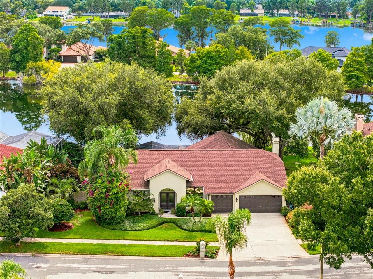Are you searching for a home where peaceful waterfront views, abundant wildlife, and everyday luxury come together? Welcome to Keystone Crossing, one of Odessa's most desirable communities, where this beautifully maintained 4-bedroom, 3-bath residence overlooks a stocked pond and offers a backyard designed to feel like your own private tropical retreat. From the moment you arrive, you'll appreciate the tranquil setting. The pond attracts an incredible variety of native Florida wildlife creating a picturesque backdrop that changes with the seasons. Whether you enjoy fishing, birdwatching, or simply relaxing outdoors, this property offers a lifestyle that's difficult to replicate. The outdoor living space is truly exceptional. Surrounded by lush tropical landscaping, the expansive screened lanai overlooks the water and provides the perfect setting for morning coffee, evening sunsets, or entertaining family and friends. The dipping pool has been renovated to also function as an in-ground hot tub, while a beautifully maintained koi pond enhances the peaceful, resort-like atmosphere. Inside, the thoughtfully designed split-bedroom floor plan offers both privacy and functionality. The spacious primary suite is tucked away from the guest bedrooms, while two oversized secondary bedrooms share a convenient Jack-and-Jill bath. The third full bath also serves as an ideal pool bath for outdoor entertaining. The heart of the home is the inviting family room, highlighted by a stunning wood-burning fireplace that has been recently remodeled with cultured stacked stone, a reclaimed wood mantel, and a striking natural Azurite Quartzite hearth. This one-of-a-kind feature creates a warm focal point that perfectly complements the home's comfortable yet refined style. Spacious living and dining areas provide flexibility for everyday living and entertaining, while large windows frame beautiful views of the pond and surrounding landscape. Some of the additional highlights include a spacious 3-car garage, quartz countertops in kitchen & baths, new flooring throughout, outdoor & indoor painting, and a newer roof.  Residents of Keystone Crossing enjoy a peaceful setting with generously sized homes while remaining just minutes from top-rated schools, shopping, dining, parks, and major commuter routes, providing convenient access throughout the Tampa Bay area. If you've been searching for a home that offers more than just square footage—one that delivers privacy, nature, exceptional outdoor living, and timeless comfort—this Odessa waterfront retreat is an opportunity you won't want to miss