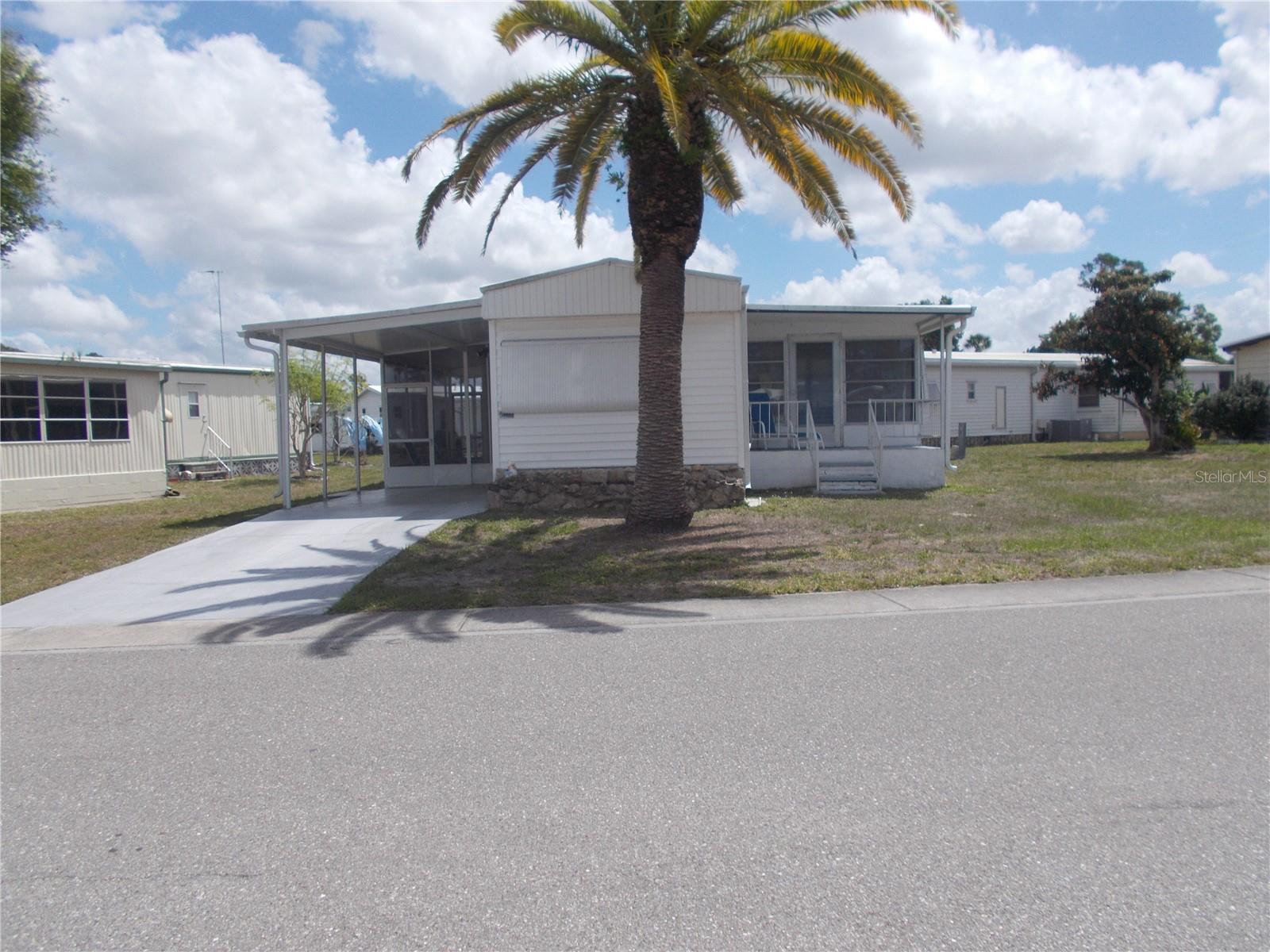 Welcome to 5039 Palena Blvd.  This is a 2-bedroom, 2 bath singlewide furnished home in the 55+ community of Holiday Park and in the PET SECTION.  You enter into the 11X17 Lanai and straight ahead is the 8X8 shed that houses your washer and dryer.  As you enter the house you have a spacious Living Room to the right and a lovely eat-in kitchen with quartz countertops, a breakfast bar and beautiful cabinets.  Off the Living Room is a 12X18 Florida room that can be used for guests and entertaining. It has a split floorplan with the bedrooms at both ends.  Your front bathroom has a stall shower, and the hall bath has a tub with a shower.  You also have a lovely porch off of the Florida room where you can sit and relax. As per the owner the roof was installed in 12/2022. In Holiday Park you own the land with a deed and your $195.00 monthly maintenance fee ($2340.00 a year) is included in your taxes. The community features 2 clubhouses, 2 swimming pools, a library, a fitness room, tennis courts, pickleball & bocce courts, to name a few. You are close to shopping, dining, entertainment, numerous golf courses, sports facilities, and SW Florida's renowned beaches. Come take a look!
Land, Site, and Tax Information