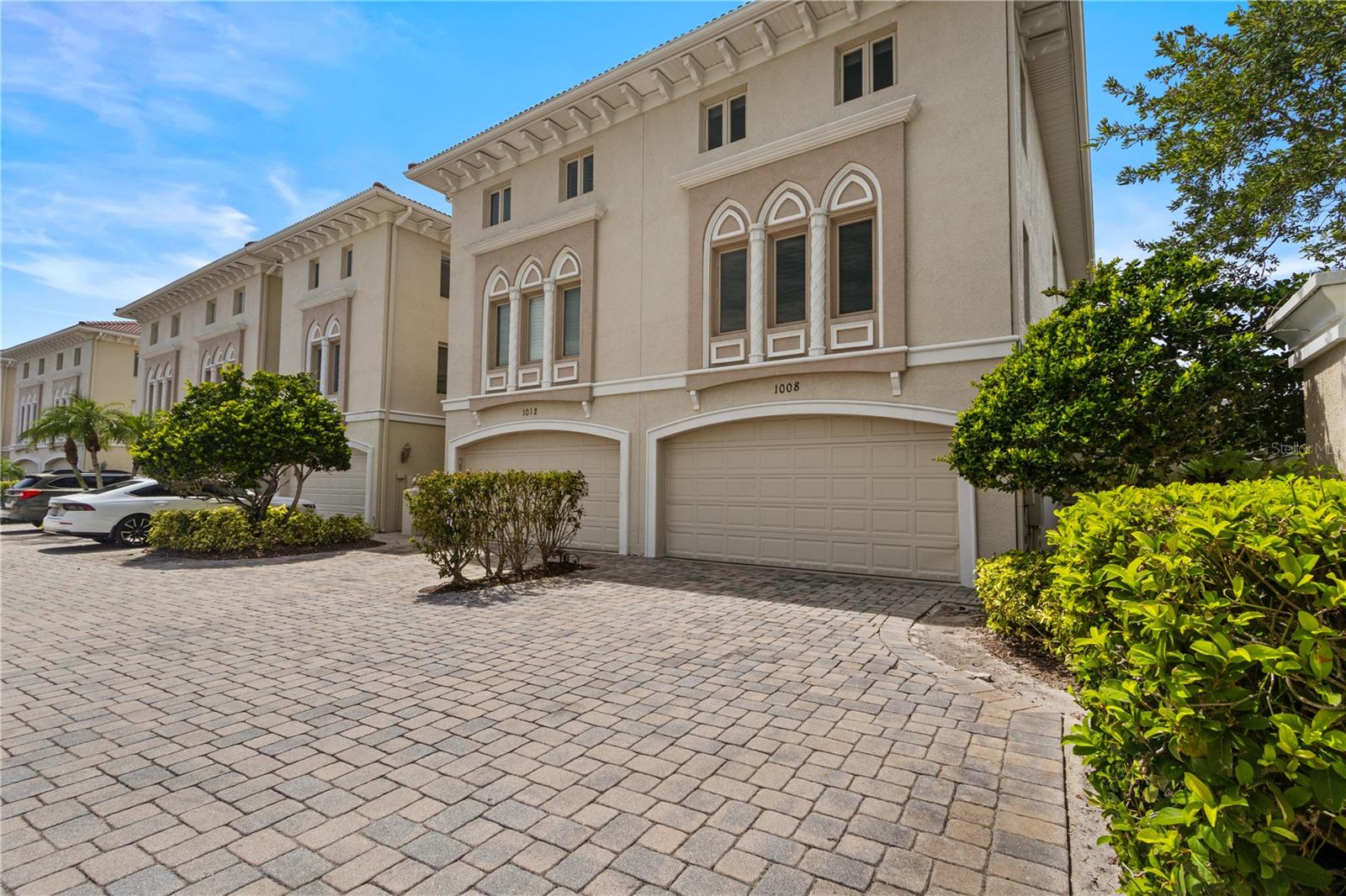 RARE OPPORTUNITY! This unique and exceptional waterfront residence in gated Portofino of Venetian Bay offers luxury living, a remarkably LOW HOA ($660), loads of privacy, and a rare connection to Weedon Island Preserve. *Property did not flood in recent storms and current flood insurance policy is assumable.* As the premier end unit (custom built by a famous professional athlete), the home is bordered by a forested bird sanctuary and park, while the backyard overlooks the preserve's mangrove-lined shoreline, docks, and abundant wildlife that includes dolphins, manatees, tarpon, a variety of spectacular birdlife and much more. Centrally located just minutes from both downtown Tampa and downtown St Petersburg, the 3000+ acre preserve provides endless opportunities for boating, kayaking, paddleboarding, fishing, birdwatching, and exploring one of Tampa Bay's most historical and diverse coastal habitats. The home’s 4-bedrooms are all ensuites, with an additional half bath conveniently located on the lower level. Wake up to stunning sunrises and birdsong and spend your days relaxing beside the heated plunge pool or launching watercraft from your private deeded dock with 13,000-lb boat lift (deep water access and no fixed bridges). Interior home highlights include a 500-bottle climate-controlled wine room, gas fireplaces in the dining room and primary bedroom, expansive walk-in closets, custom cabinetry and built-ins, custom trim work and crown molding, whole-home audio/visual system, and a gourmet chef's kitchen featuring stainless appliances, warming drawer, icemaker, a new Sub-Zero refrigerator, a massive center island with bar seating, and two-inch thick Pearl granite countertops and backsplash. A new roof (2026) and two HVAC systems (2022) with air purification provide added peace of mind. Ideally located minutes from downtown St. Petersburg, Tampa, premier dining, shopping, beaches, airports, and the area's most celebrated destinations. This home is truly a hidden gem not to be missed! Schedule your showing today.