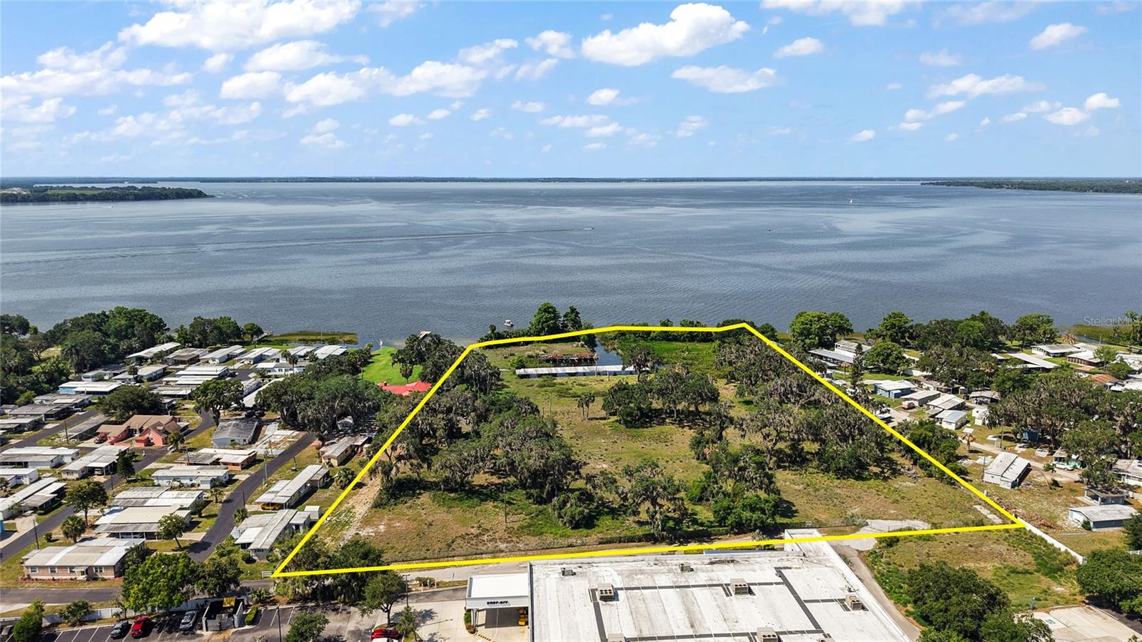 Offering is for 6.93 +/- Acres directly on Lake Harris with over 400 +/- ft of lake front. Site is zoned CP, Lake County and less than one block off US Hwy 441 and under an hour to Orlando or The Villages. Ideal use for 70 +/- room hotel resort plus marina.  The popular and beautiful Harris Chain of Lakes in Lake County, Florida, is a chain of seven lakes that total approximately 76,000 +/- acres of water. The lakes are connected by canals and include Lake Harris and Little Harris, Dora, Carlton, Beauclair, Eustis and Griffin. Potential for less units - single family residential.   All information is believed accurate and correct but not guaranteed or warranted and subject to change without notice.