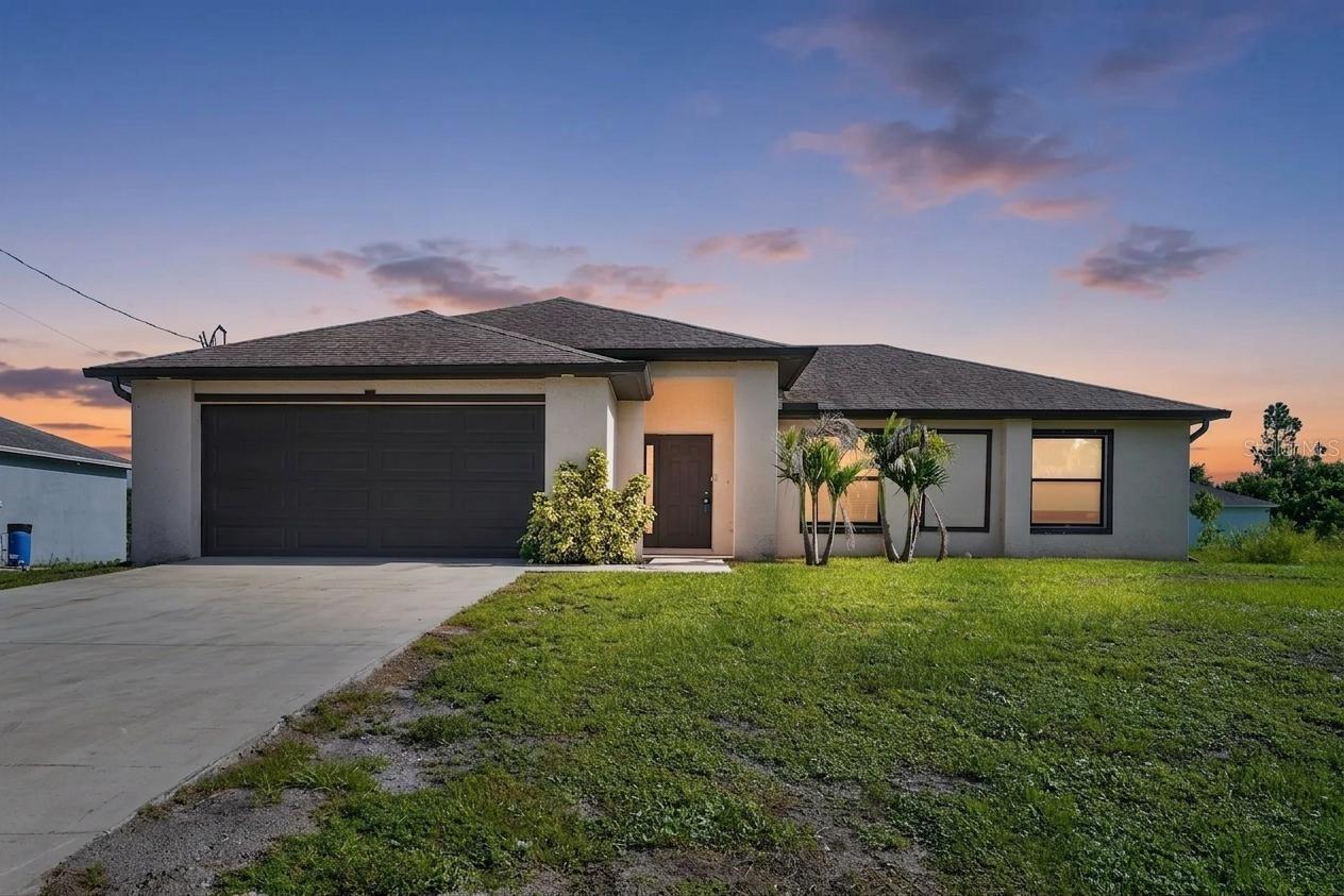 Your new home, built in 2020, has 3 bedrooms, 2 bathrooms with a large 2 car garage. Featuring modern construction, a well-designed split-bedroom floor plan and an impressive 40-by-10-foot lanai for enjoying the Southwest Florida lifestyle. Inside, the bright open layout features tile flooring, a spacious living room and a comfortable flow between the kitchen, dining and gathering areas. The kitchen is both functional and inviting with a large center island, ample cabinetry, generous preparation space and included appliances. The private primary suite is thoughtfully separated from the guest bedrooms, while the generously sized secondary bedrooms provide flexibility for guests, a home office or additional living space. Step outside to the expansive lanai, perfect for relaxing, entertaining or enjoying your morning coffee. The rectangular quarter-acre lot offers plenty of room for outdoor activities, gardening or the addition of a future pool. Additional features include interior laundry with a utility sink, ceiling fans, a water-softening system, an attached two-car garage with an opener, and a paved driveway. Located on a cul-de-sac with no HOA, this home provides added freedom without monthly association dues. Solid block construction, a functional one-story design and newer construction make this an exceptional opportunity for buyers seeking space, value and comfort in Lehigh Acres. Ready for your finishing touches and Virtually staged for your enjoyment!