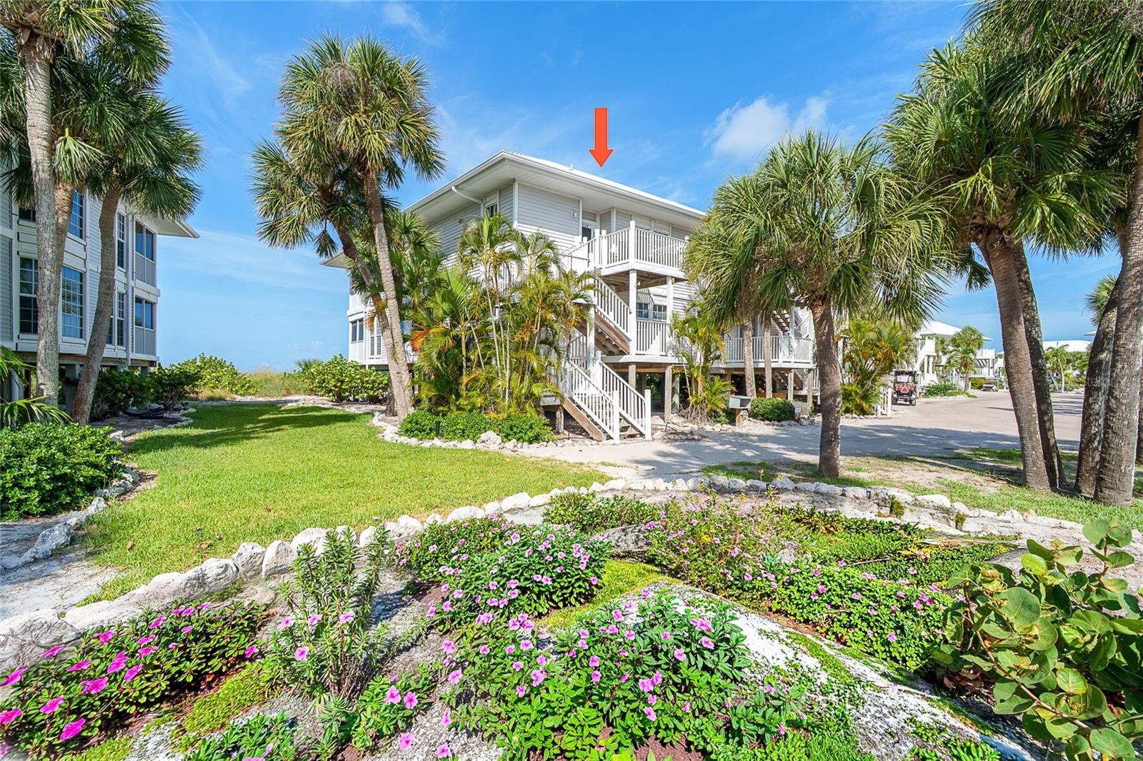 Nestled within the lush tropical landscape of Palm Island Resort, this comfortably appointed 3-bedroom, 3-bath beachfront condominium offers the ultimate coastal living. Inside, generous living areas provide ample room for family and guests, while multiple private bedroom suites ensure comfort and privacy. Enjoy morning coffee or evening cocktails from the spacious decks surrounded by swaying palms and gentle Gulf breezes. The panoramic view from the upper deck is spectacular. Start collecting shells and sharks' teeth from the 7 miles of pristine sand beach. This exceptional residence offers access to the resort's premier amenities, including pools, tennis and pickleball courts, fitness facilities, island style dining, and Coconuts Cafe for ice-cream, provisions or coffee. Palm Island is a rare barrier-island paradise situated between Sarasota and Fort Myers, accessible only by private boat or a short car ferry ride, creating an exclusive "away from it all" lifestyle with over seven miles of uncrowded beaches and natural beauty. 
Whether you're seeking a luxury vacation getaway, or full-time island residence, this extraordinary beachfront condominium delivers the best of Southwest Florida coastal living in one of the Gulf Coast's most treasured island communities.