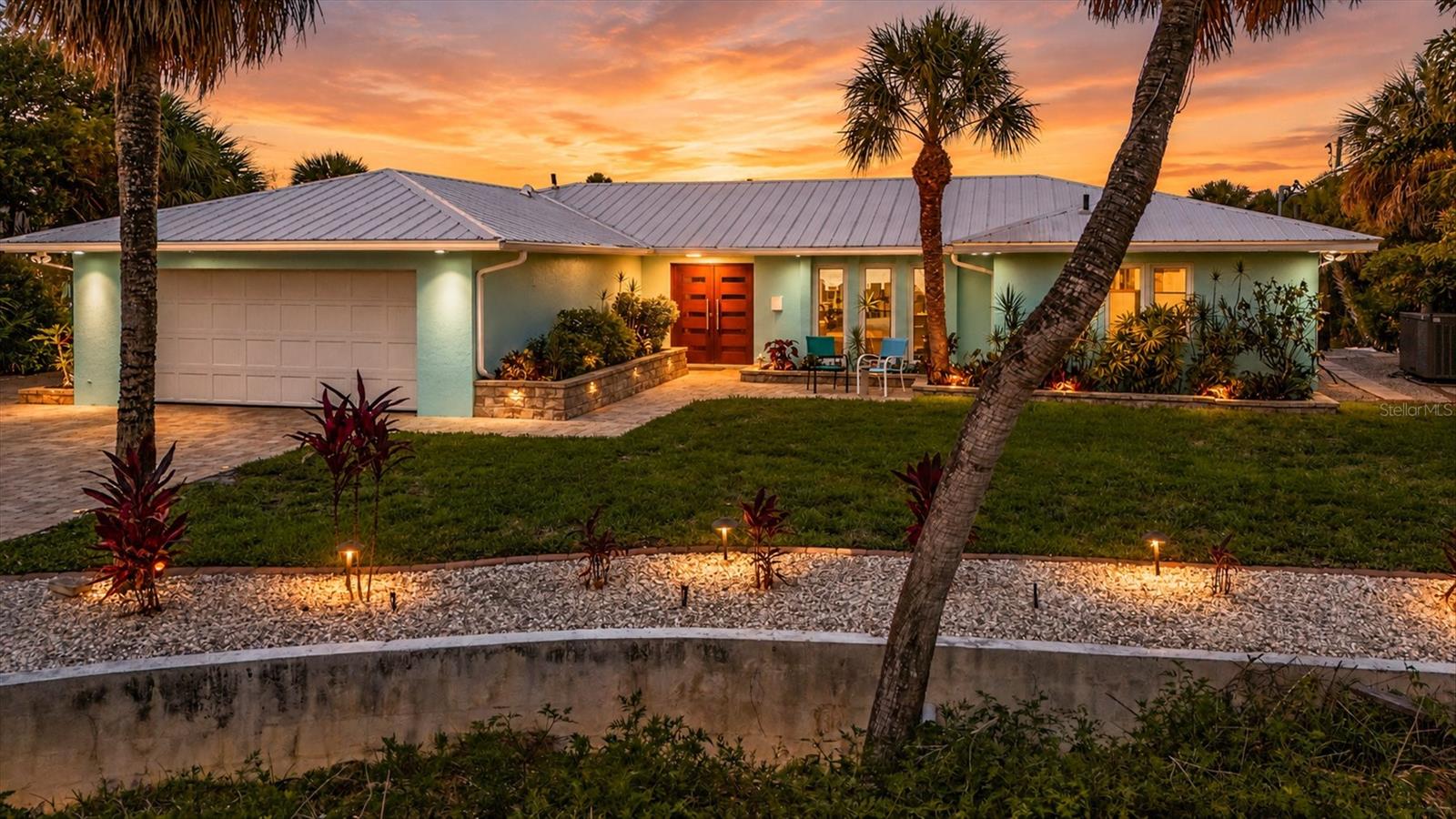 Waterfront luxury meets unmatched storage and garage space on highly desirable Manasota Key. Whether you're a car enthusiast, collector, boater, or simply need room for RVs, watercraft, and recreational toys, this exceptional property delivers. The impressive 60’x40’ oversized garage is a rare find, featuring three car lifts and abundant space for vehicles, hobbies, and storage.
Beyond the garage, you'll discover a spectacular waterfront lifestyle overlooking beautiful Lemon Bay. Enjoy direct boating access from your private dock and 18,000-pound boat lift, with no fixed bridges standing between you and the Intercoastal Waterway, Gulf waters, waterfront restaurants, and endless boating adventures.
This beautifully maintained 3-bedroom split floor plan offers spacious living throughout, including a large open-concept living room, expansive dining area perfect for entertaining, and a well-appointed kitchen featuring custom mahogany cabinetry, granite countertops, and stainless-steel appliances. Tile flooring runs throughout the home, while stunning water views can be enjoyed from multiple rooms.
Step outside to your private resort-style retreat. The custom 18' x 40' saltwater pool showcases elegant tile accents, lighting, and water features, while the jetted spa provides the perfect place to unwind as you overlook Lemon Bay. The tiki bar creates an inviting gathering space for family and friends, complemented by an outdoor dining and grilling area designed for memorable waterfront entertaining.
For added peace of mind, the home experienced no water intrusion or damage during the 2024 hurricanes and comes with a whole house generator.  Adding to the appeal, deeded Gulf beach access is located directly across the street, offering convenient access to pristine sandy beaches and breathtaking sunsets. Beachside restaurants, entertainment, and the public beach are all less than two miles away.
This extraordinary property combines luxury waterfront living, exceptional boating access, deeded beach rights, and one of the most impressive garages on Manasota Key. Create a life you don't need a vacation from.