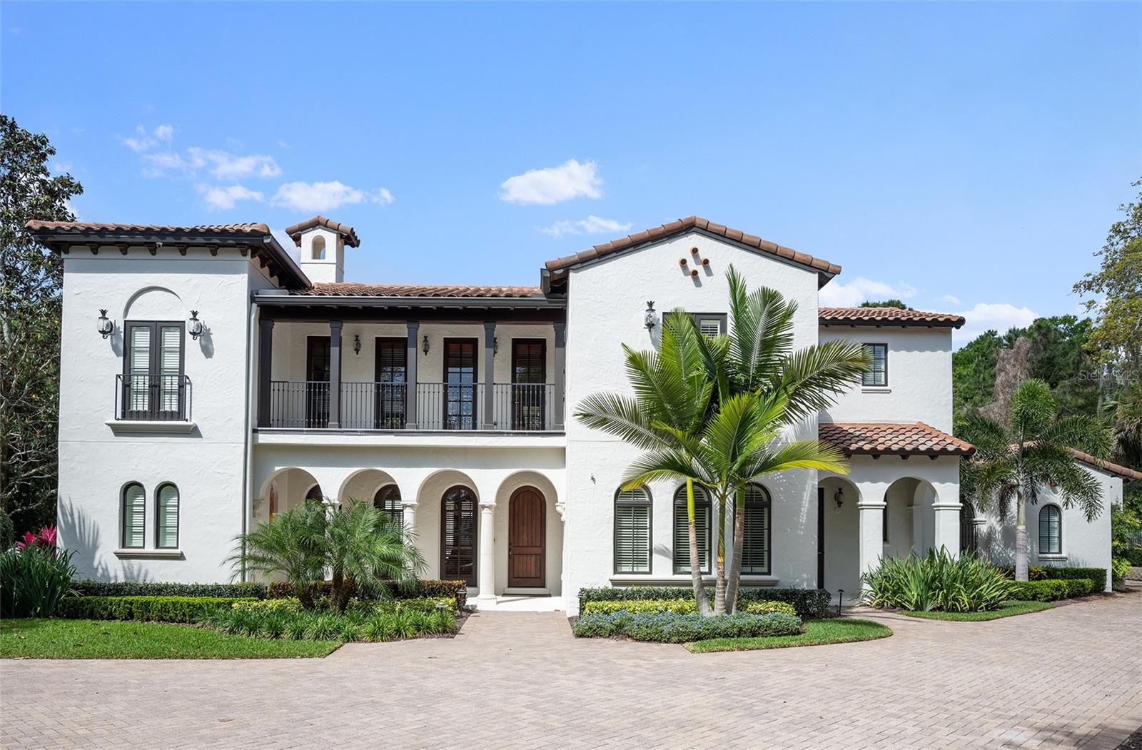 WINDSONG - WINTER PARK – A Maroon Fine Homes masterpiece and COMPLETELY renovated in 2022. This property combines luxury, functionality, and location, making it a perfect choice for those looking to enjoy the best of Winter Park living! Five bedrooms, six baths with the amazing primary suite located on first floor and shell stone flooring though out entire home except theater room. Master suite features a luxurious bath with double vanities, separate shower and tub plus washer and dryer in large walk-in closet to save a trip to the laundry room on the other side of this 6,215 sq. ft. home. From the living room with fireplace, you enter the informal dining area, large open kitchen, and a grand family room.  A gourmet kitchen offers a hidden walk-in pantry, wonderful center island with nice long counter for seating open to the family room. Kitchen includes Dacor appliances with unmatched design, American made and the preferred choice for culinary enthusiasts.   An office is on the first floor off from the foyer, which leads to a butler’s pantry (with another large walk-in pantry), which is adjacent to the large laundry room with another set of washer/dryer, and a custom dog bathing area!  Across from the living room is a bedroom with ensuite bathroom perfect for guests or mother-in-law needs (pocket door separates this area from living room). Additionally downstairs is a theatre room with comfy chairs for family fun nights! Just outside the theatre room is a hall bar area with subzero tall wine fridge w/2 refrigerated beverage drawers/ 2 more subzero ones, another refrigerator and freezer w/ice maker and a pool full bath just down the hall. Upstairs is an open space perfect for a library, play area, another living room, etc. and is positioned between three more bedrooms with ensuite bathrooms. To enjoy morning coffee or evening wine there are 4 porches and 2 balconies. 3 garage spaces.....2 car garage and separate 3rd garage.  The lay out of this luxury home is unique as it wraps around (U shape) the pool, lanai, and outdoor kitchen. Three a/c units replaced in 2014. Large, private backyard with NO rear neighbors.  Located in one of Winter Park’s most sought-after neighborhoods, Windsong offers its residents Chain of Lake Access, community pools, splash park, pontoon boat, paddleboards. Top rated schools and minutes to Park Avenue shopping and dining.