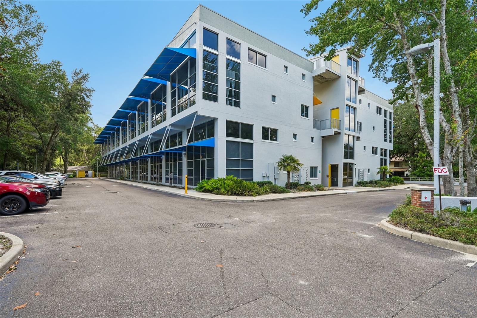 Virtually Staged. Experience modern loft-style living in this distinctive 3-bedroom, 3.5-bath condo located in Lofts Oasis, one of Gainesville’s most convenient and connected areas. Just minutes from the University of Florida, UF Health Shands Hospital, Archer Road’s shopping and dining corridor, and major commuter routes, this home places you close to everyday essentials while still offering a private residential setting. Inside, the home showcases a true industrial-inspired design with polished concrete flooring throughout and durable concrete block construction that sets it apart from traditional condo living. The open main level is bright and flexible, with clean lines, high ceilings, and a natural flow that enhances the sense of space. A private bedroom with an en-suite bath is located on the main floor, offering added convenience and separation from the main living area. Upstairs, two additional bedroom suites provide comfortable and well-defined spaces, including a loft-style bedroom that overlooks the living area below, creating an open and connected feel. Each level is designed to support a variety of lifestyles, whether for everyday living, guests, or dedicated workspaces. This loft-style condo offers modern design in one of Gainesville’s most convenient locations. With its rare availability in Lofts Oasis, strong architectural character, and close proximity to Gainesville’s key destinations, this property presents a unique opportunity for both homeowners and investors alike. Mortgage savings may be available for buyers of this listing.