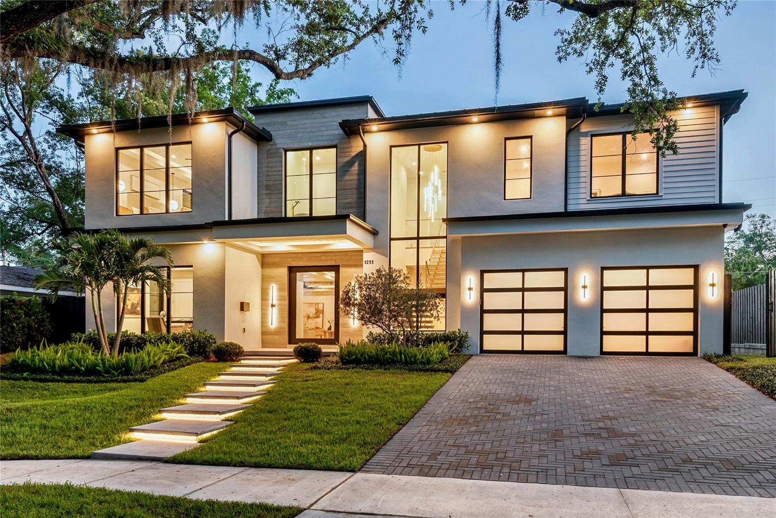 BEVERLY SHORES/ROSE ISLE WELCOMES THE NEWEST ADDITION TO THE ORLANDO/WINTER PARK LUXURY NEW CONSTRUCTION HOME MARKET!  BUILT BY RARE BUILDERS! A BUILDER THAT SET THE BAR FOR INTRIGUING LUXURY CUSTOM HOMES AND CONTINUES TO RAISE IT! This latest home is a shining example and has come together perfectly as a unique, awe-inspiring estate offering an unparalleled combination of exceptional function, modern aesthetics and elegance. Prominently sited on a large elevated lot... an eye catching show piece with a dramatic front elevation and grand stylish presence boasting 4600 sq ft of living space (almost 3000 on the ground for alone).. .  Floor plan features a large private ground floor primary suite, second large ground floor guest suite, and an additional second floor
primary suite option. Please see floor plans in photos and CLICK ON TOUR LINK FOR A COMPREHENSIVE VIDEO WALK THROUGH TOUR.
This rare ground floor design offers space and a configuration that you just can't find in the current market: Multiple suites, a dramatic entrance with floating staircase , expansive main kitchen/dining/living area that integrates perfectly with the resort-style outdoor/pool/spa area, fire & water features, two fireplaces, an incredibly well appointed kitchen + walk-in butler's pantry and additional front study. Entire home is adorn with absolutely beautiful finishes and design features from the extensive use of glass to the sophisticated and warm wood ceilings, gorgeous stone and exceptionally well curated final fixtures and finishes features that have to be seen in person to truly appreciate the feel and impact made by profession design planning at this level throughout the entire home. Second floor offers a large loft with high and bright exposure, the second primary suite option, two additional large bedrooms and two more full baths.... 6 baths total! You will not find a better opportunity to secure a highly detailed, unique, luxury home in the Orlando/Winter Park area that offers the feel, presentation and function of 1211 Munster. Located in a fantastic  location in the highly desirable Audubon Park School K-8 School District. Minutes to DT,Orlando, DT Winter Park, WP Park Ave. Shopping, Winter Park Village, Advent Health, ORMC and more. An exquisite Luxury Estate in one of Central Florida's most dynamic areas and desirable areas!
