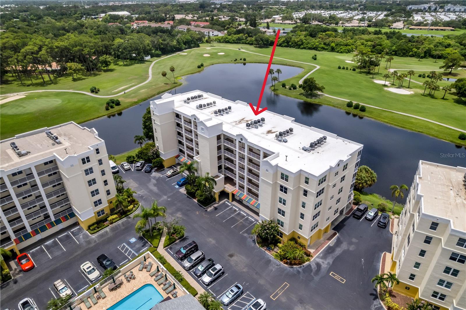 This exceptional END UNIT condominium delivers everything you’ve hoped for—AND MORE. Rarely does a 3-BEDROOM residence offer such SWEEPING GOLF COURSE AND LAKE VIEWS from nearly every window, at this remarkable value.  Built with newer construction standards and designed for modern living, the home features an OPEN FLOOR PLAN, abundant natural light, and an EXCITING PRICE POINT that sets it apart.  Take the SECURE ELEVATOR to the third floor and follow the wide, covered walkway to your private end unit. Inside, an inviting open foyer flows effortlessly toward the spacious living areas and bedrooms. The cheerful, well-sized KITCHEN offers generous cabinetry, ample counter space, a pantry, and a seamless connection to the Great Room, enhanced by nearly 9-FOOT CEILINGS.  The dining and living areas open to a LARGE, SCREENED BALCONY showcasing expansive GOLF, LAKE, AND NATURE VIEWS—the perfect backdrop for morning coffee or sunset unwinding.  The PRIMARY SUITE is a true retreat with balcony access, space for a cozy sitting area, his-and-hers walk-in closets with built-ins, and an EN-SUITE BATH featuring a walk-in shower with bench. Two well-appointed guest bedrooms provide privacy, generous closets with built-ins, and a shared bath. Additional hall closets with Built-ins and a large laundry room offer excellent storage options.  Your reserved UNDER-BUILDING PARKING keeps your vehicle protected from the elements. The community features a HEATED POOL, spa, and CLUBHOUSE for year-round enjoyment.  MAJOR COMMUNITY UPDATES include a 2024 ROOF, 2026 exterior paint, and completed Milestone Inspection and SIRS Study.  Located on the beautiful East Bay Golf Course, yet just MINUTES FROM BEACHES, shopping, dining, and airports, this residence offers the ideal blend of convenience and FLORIDA LIFESTYLE.  Come see it for yourself—you may just find the PERFECT PLACE TO CALL HOME!