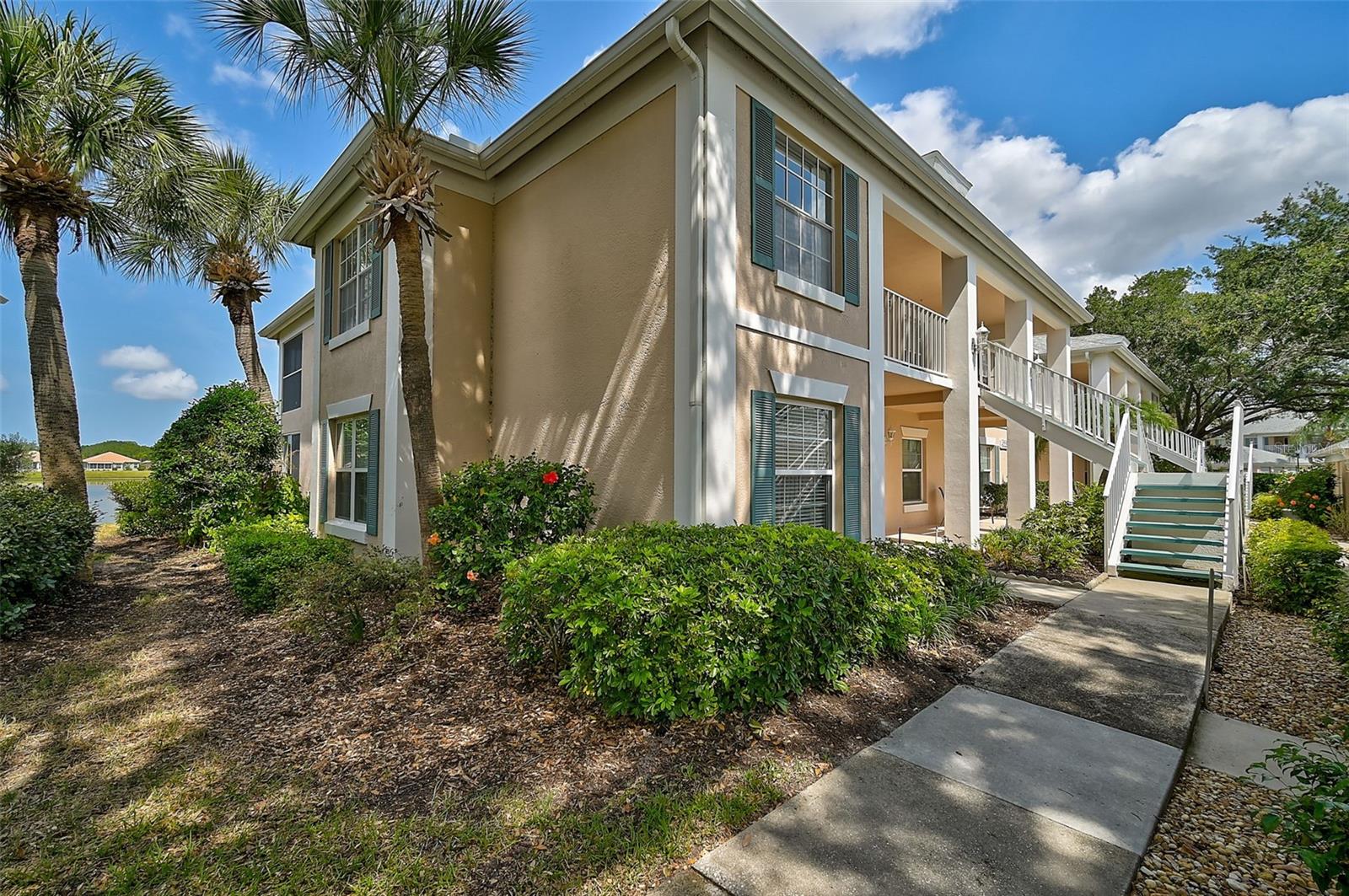 Incredible opportunity, don’t miss out! Experience the perfect combination of comfort, style, and tranquil water views in this beautifully maintained 1st floor END-unit condo featuring 2 BR/2 BA + a versatile den, and a detached garage. Enjoy peaceful lake views from the main living areas and the spacious primary suite. The thoughtfully designed open-concept living and dining area is ideal for everyday living and entertaining. The kitchen showcases warm wood cabinetry and wood flooring, creating an inviting and functional space. The primary suite offers serene lake views and a well-appointed en-suite bath with a walk-in shower and comfort-height counters for added convenience. A full-size washer and dryer are located inside the residence for everyday ease. Relax and unwind in the glass-enclosed lanai while taking in panoramic lake views — the perfect setting for morning coffee or evening sunsets! Perfect your swing on Peridia Golf & Country Club's 18-Hole Executive Golf Course. Cool off on hot summer days with a refreshing dip in your choice of two community pools. Dance the night away to live music at the country club's Friday night events or unwind with a tropical drink at the tiki bar. Engage in a variety of activities such as PICKLEBALL, tennis, mahjong, poker, and bowling, offering entertainment for all interests. Enjoy the convenience of nearby amenities, including shopping centers, restaurants, and recreational facilities, all within easy reach. Contact us now to schedule a private viewing and experience the beauty and tranquility of this  property!
