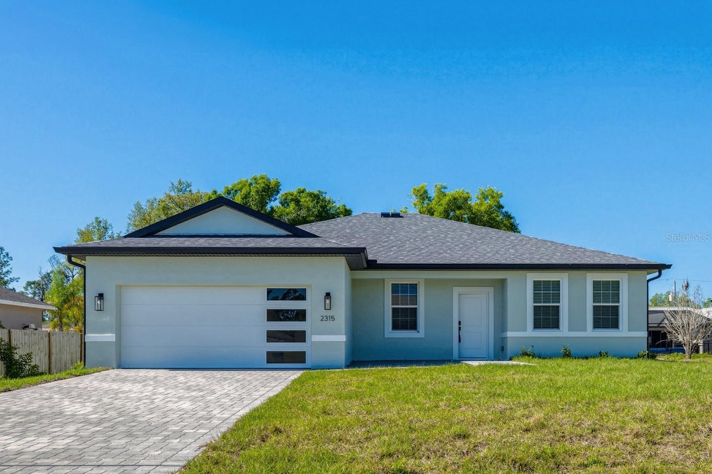 JUST COMPLETED! BRAND NEW 4 BEDROOM, 3 BATH, 2-CAR GARAGE HOME IN NORTH PORT! Stunning new construction home, designed with thoughtful details for comfort and style. Open floor plan with high ceilings, luxury vinyl flooring, contemporary and recessed lighting plus much more. Well-appointed kitchen offers soft-close cabinetry, quartz waterfall countertops, tile backsplash, stainless steel appliances, closet pantry and center island overlooking the dining and living areas. Generous primary bedroom with his and hers walk-in closets and en-suite bath featuring dual sinks, LED mirror, and walk-in tile shower. Split floor plan provides guests with plenty of privacy, featuring 3 additional bedrooms, a full guest bath, and one bedroom with its own ensuite bath perfect for hosting guests or family. Outdoor entertaining area features covered lanai and plenty of room for a pool in the backyard. Additional highlights include impact windows and doors, smart thermostat, water filtration system, epoxy garage flooring, and paver driveway. Nestled on a quiet street you'll enjoy the peace of suburban living while still being just minutes away from shopping, dining, and everyday conveniences with easy access to I-75. With North Port's affordability, friendly atmosphere, and strong community feel it's easy to see why so many are choosing to call this area home. Don’t miss this opportunity! Schedule your private showing today!