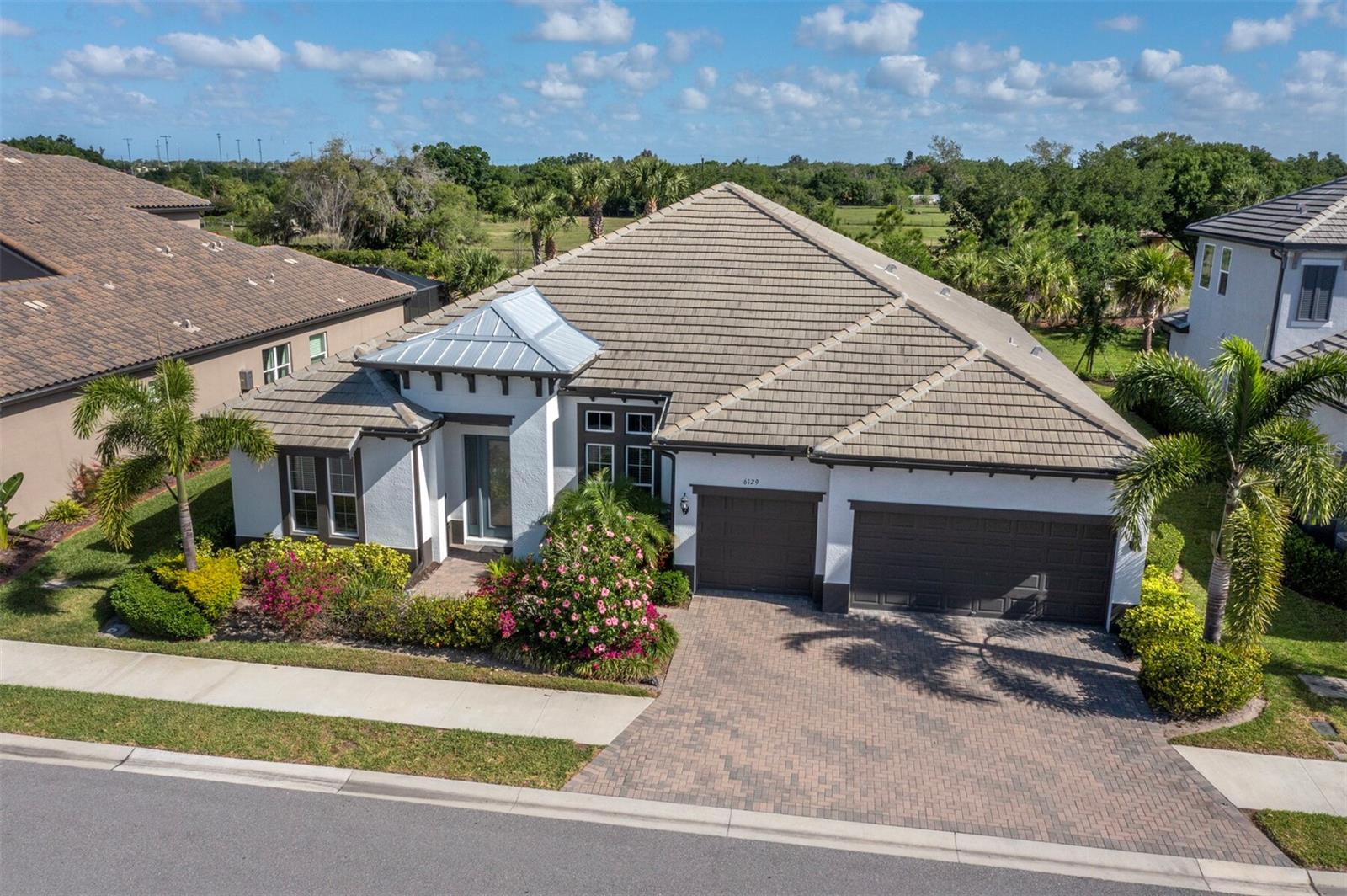 Virtually Staged. Welcome to Rivo Lakes, a gated community in Sarasota where modern elegance and everyday comfort come together beautifully. Built in 2022, this exceptional residence offers over 3,000 square feet of thoughtfully designed living space with 4 bedrooms, 3 bathrooms, a versatile flex room ideal for a home office or den, and a highly sought-after open floorplan. Designed for both effortless entertaining and relaxed daily living, the expansive great room flows seamlessly into the kitchen and dining areas, creating a sophisticated yet inviting gathering space. High ceilings, refined finishes, and expansive living spaces enhance the home's polished, contemporary feel. The spacious primary suite provides a private retreat with spa-like comfort, while additional bedrooms and flexible living areas offer ideal space for guests, hobbies, or everyday living.
Step outside to your own private Florida oasis featuring a beautiful pool and spa with inviting outdoor living space perfect for year-round enjoyment. Surrounded by the privacy and prestige of Rivo Lakes, residents enjoy a serene setting just moments from top-rated schools, premier shopping, dining, golf, and Sarasota's Gulf beaches. An exceptional opportunity to own a newer luxury home in one of Sarasota?s desirable gated communities.
