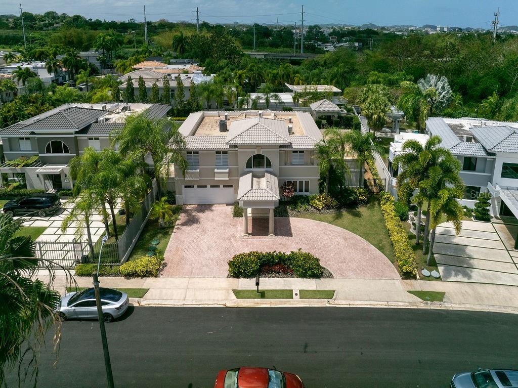 Welcome to Palma Real Estates – Luxury Redefined

Experience unparalleled luxury at Palma Real Estates, a distinguished residence that defines sophisticated living. This exquisite home, boasts 5 bedrooms, 4 full bathrooms, and 2 half baths, offering both elegance and comfort.

Spanning approximately 5,400 square feet of gross living area on a 1,200-square-meter lot, this grand estate welcomes you with a stunning entrance foyer leading to beautifully designed living spaces. The first floor impresses with a formal dining room, a spacious family room, a formal living area, and a casual dining space. At the heart of the home is a gourmet Poggenpohl kitchen, featuring high-end appliances, a walk-in pantry, and top-tier finishes.

Step outside to your private oasis, complete with a covered terrace, an inviting swimming pool, a gazebo with a half bath, and lush green surroundings—ideal for relaxation or entertaining.

The luxurious master suite is a true retreat, featuring an opulent en-suite bathroom with double sinks, a jetted tub, a walk-in shower, and a makeup vanity. A spacious, climate-controlled walk-in closet with a secure locking jewelry closet completes this magnificent space.

Additionally, the property offers a junior suite with its own en-suite bathroom and walk-in closet, ensuring privacy and comfort for guests or family members.