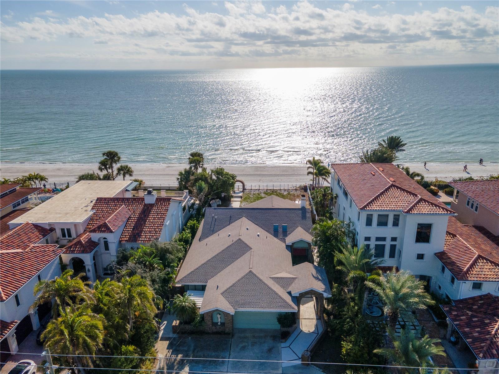Positioned in the heart of Redington Beach's ELITE RESIDENTIAL ROW, 16110 Gulf Blvd stands as a prime investment amidst a landscape of distinguished beachfront homes and compounds.  This is a once in a generation opportunity to get an "old Florida" beach house or build your dream oceanfront home.  
Unlike neighboring Beach Towns where coastline views are often compromised by towering condo complexes obscuring coastal views, this property offers unparalleled, unobstructed vistas of the pristine Florida shoreline. With 65 feet of well-maintained gulf frontage and ideal setback, the lot is primed for the construction of a large contemporary luxury residence, tailored to meet the discerning tastes of its future owner. 
The existing structure, renovated in the 1980s, is completely habitable and ensures immediate utility and comfort, serving as a functional living space.  The home features vaulted ceilings, open floor plan, and great room and kitchen facing the water. 
Renderings have been provided by John Cannon to depict a home that could be built on the property.
Prospective residents will enjoy direct access to Redington Beach's renowned white sands and crystal-clear Gulf waters. Additionally, the strategic location of 16110 Gulf Blvd provides convenient proximity to St. Petersburg, downtown Tampa, Amalie Arena (TB Lightning), Tropicana Field (TB Rays), Raymond James Stadium (TB Bucs), George Steinbrenner Stadium and various arts and cultural exhibits along the Gulf Coast.  In addition, the home is just minutes to restaurants, world class golf courses, and shopping.  Area beaches and bays are world renowned for boating, fising, and other water activities.  
This property represents an exceptional opportunity for those seeking a distinguished coastal lifestyle with the added benefit of easy access to the vibrant entertainment and cultural offerings in the surrounding areas.