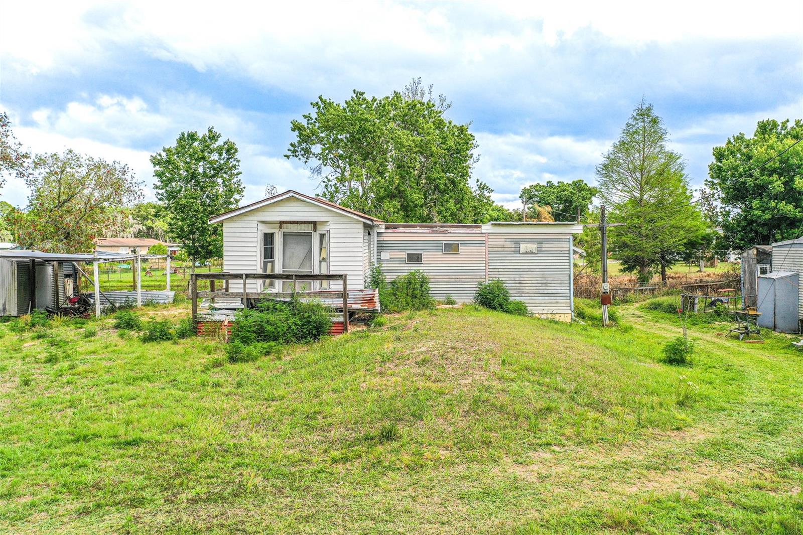Waterfront Opportunity on Lake Lowery! This mobile home sits on a .3-acre lot with canal frontage leading directly to Lake Lowery—perfect for boating, fishing, or simply enjoying stunning sunsets and watching the wildlife from your patio. The home is a blank canvas, in need of a complete upgrade and being sold as-is, offering a rare chance to create your very own lakefront retreat. The holding tank is at the front of the property, and the well is located under the carport. Bring your vision—and your boat—and transform this property into the ultimate peaceful sanctuary on the water.