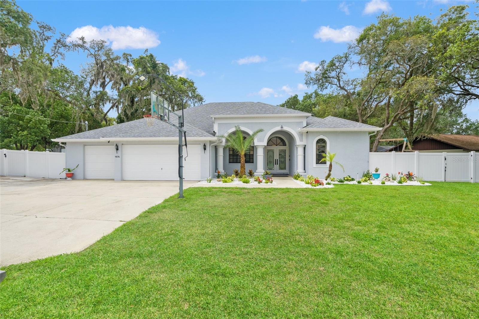 Welcome to 9076 Gallup Road, a spacious and well-maintained 4-bedroom, 3-bathroom pool home situated on a quiet no-thru street in the heart of Spring Hill with no HOA and no direct rear neighbors. Offering a light and bright modern feel, this home features an inviting double-door entrance, soaring ceilings with beautiful tray details, oversized windows overlooking the pool and backyard, fresh interior paint, modern fixtures and lighting, tile flooring throughout the main living areas, and a cozy wood-burning fireplace in the family room.

The versatile layout includes both a formal living room and a separate family room, giving plenty of space to spread out. The kitchen is centrally located and features a dinette area, walk-in pantry, abundant cabinet space, and views of the family room and pool.

The spacious primary suite offers direct access to the pool lanai and features an ensuite bathroom with a dual-sink vanity and walk-in shower. Bedroom four includes its own private ensuite bathroom with an updated step-in shower and direct access to the lanai, making it ideal as a convenient pool bath. Bedrooms two and three are generously sized and share a full updated hallway bathroom.

Enjoy Florida living year-round from the screened lanai featuring an in-ground pool, outdoor shower, and a sauna! The backyard offers privacy with vinyl fencing, an additional fenced area, no direct rear neighbors, a storage shed, and an additional concrete pad for extra storage or parking.

Additional highlights include an amazing 3-car garage, an oversized driveway for additional parking, an HVAC system that was updated in 2022, a roof that was replaced in 2022, and a convenient location close to shopping, dining, medical facilities, and everyday conveniences. Offering a great mix of space, privacy, and practical living areas, this property is ready to fit a variety of lifestyles. Enjoy room to relax, entertain, and make lasting memories both inside and out. Don't miss your chance to see everything this home has to offer—schedule your showing today!